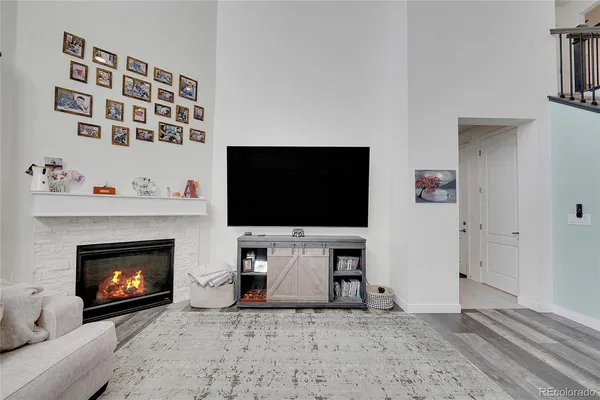 a living room with a fireplace and a flat screen tv
