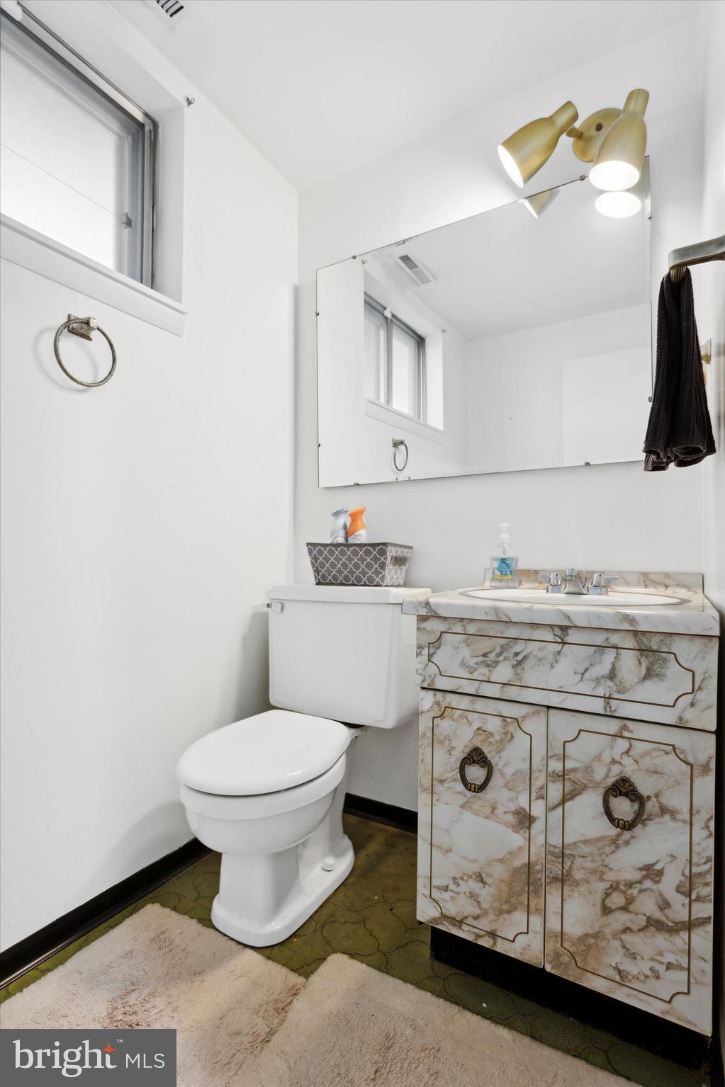 1611 Forest Drive Williamstown, NJ 08094 - Photo 27 of 31 a bathroom with a toilet sink and mirror