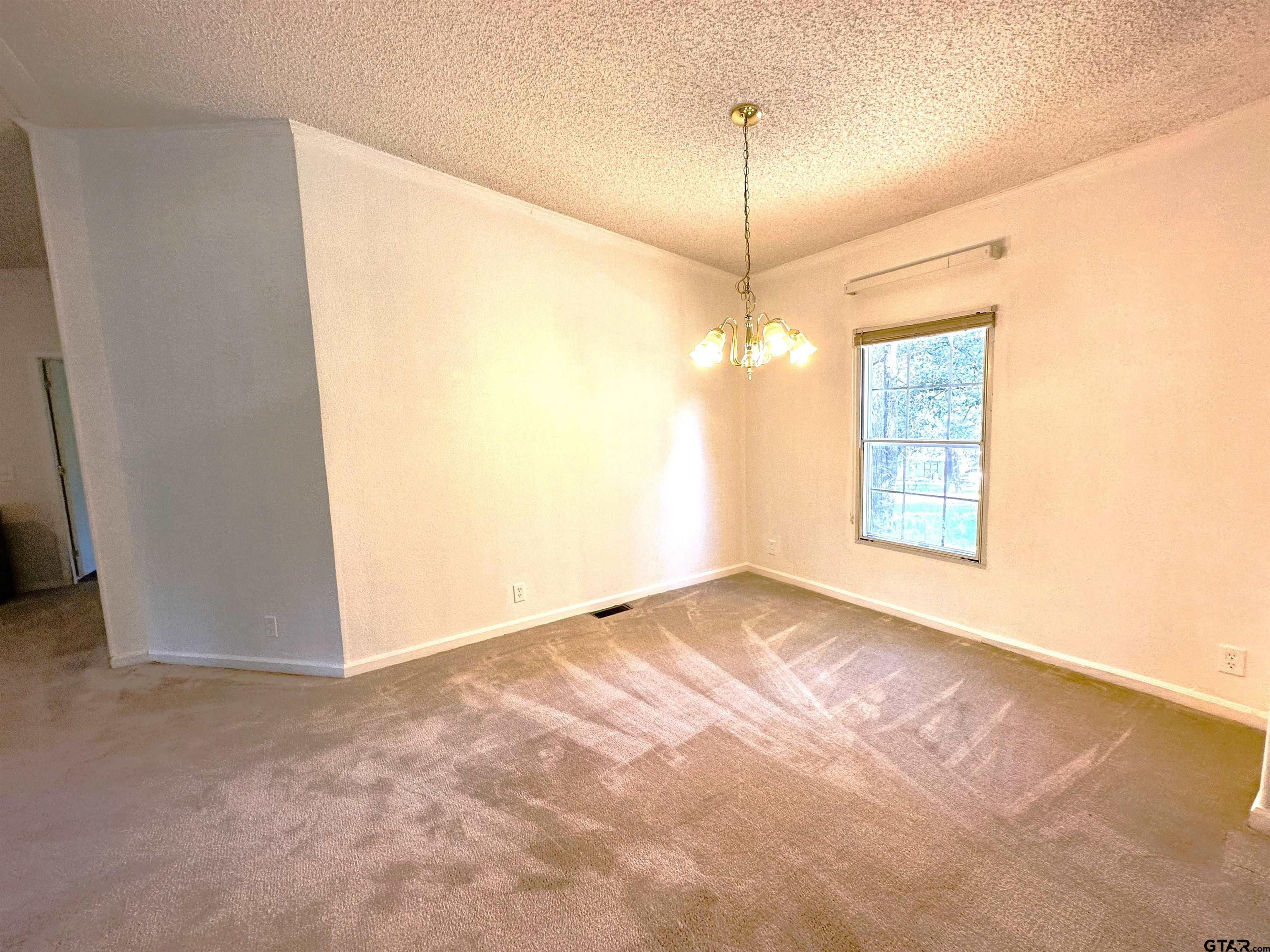 21232 Sand Jack Road Larue, TX 75770 - Photo 11 of 39 a view of an empty room with window and chandelier fan