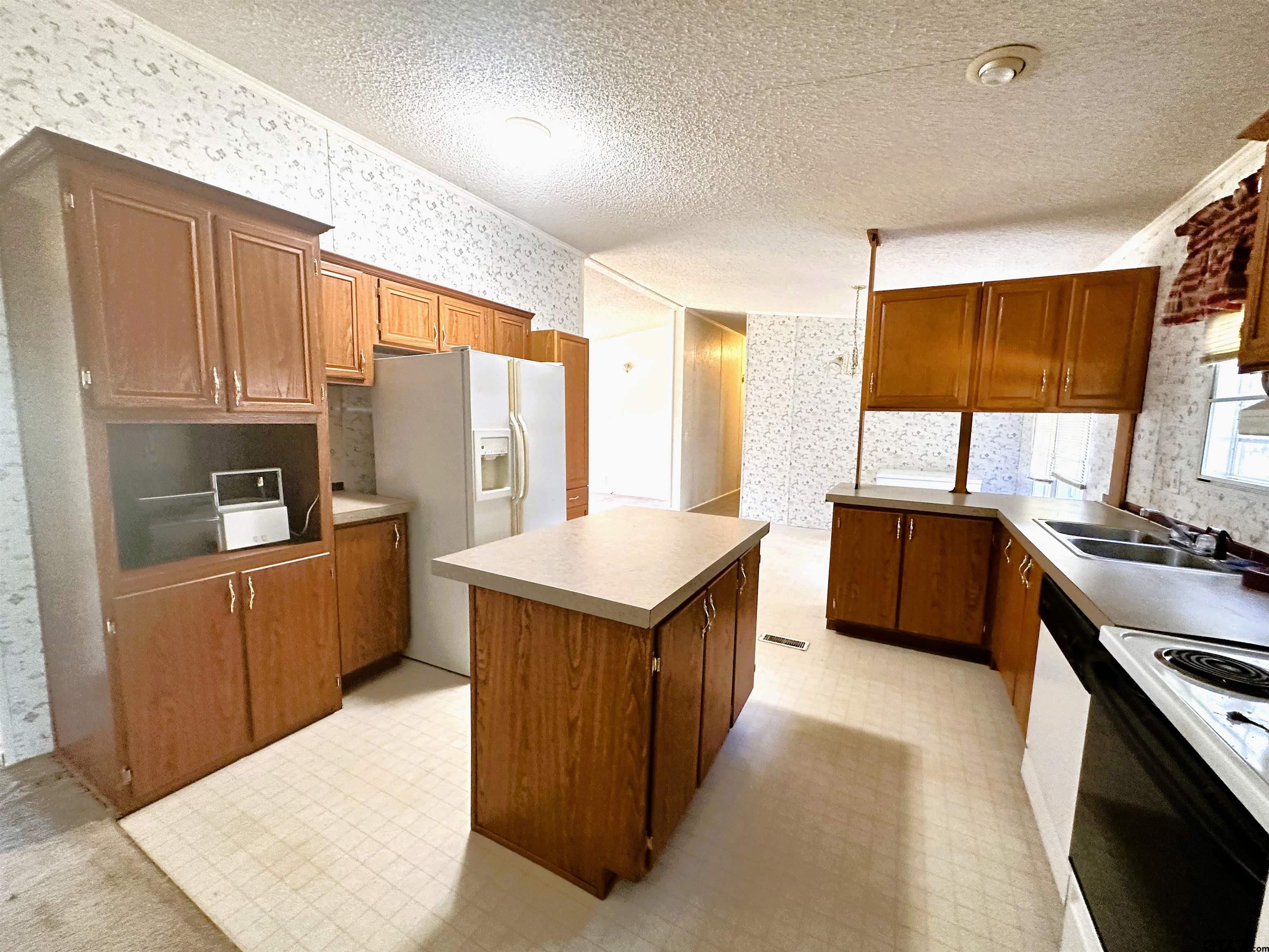21232 Sand Jack Road Larue, TX 75770 - Photo 15 of 39 a kitchen with stainless steel appliances granite countertop a stove top oven a sink a refrigerator and a cabinets