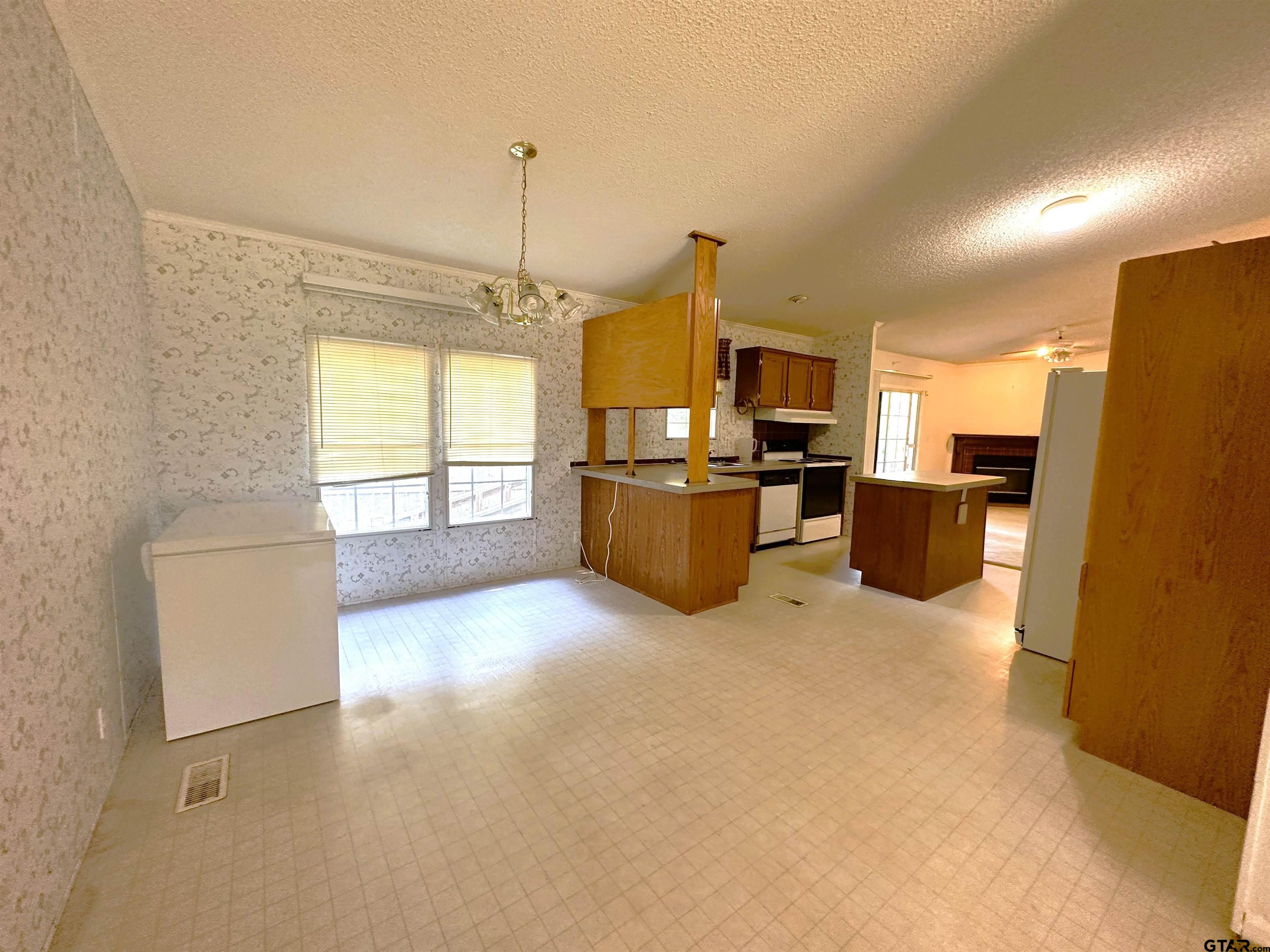 21232 Sand Jack Road Larue, TX 75770 - Photo 18 of 39 a view of a kitchen with a refrigerator a microwave and a sink
