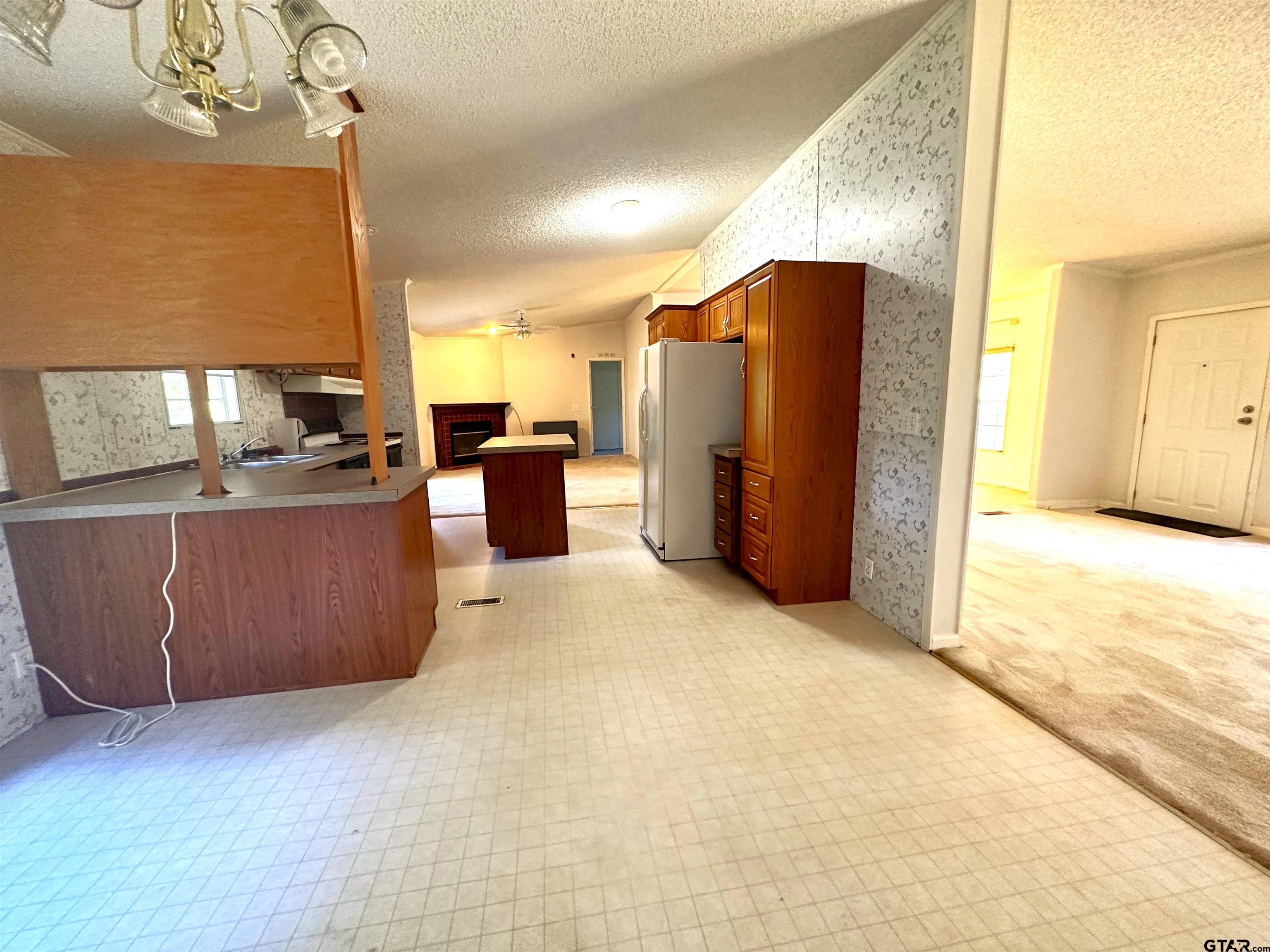 21232 Sand Jack Road Larue, TX 75770 - Photo 20 of 39 a view of a kitchen with furniture and a refrigerator