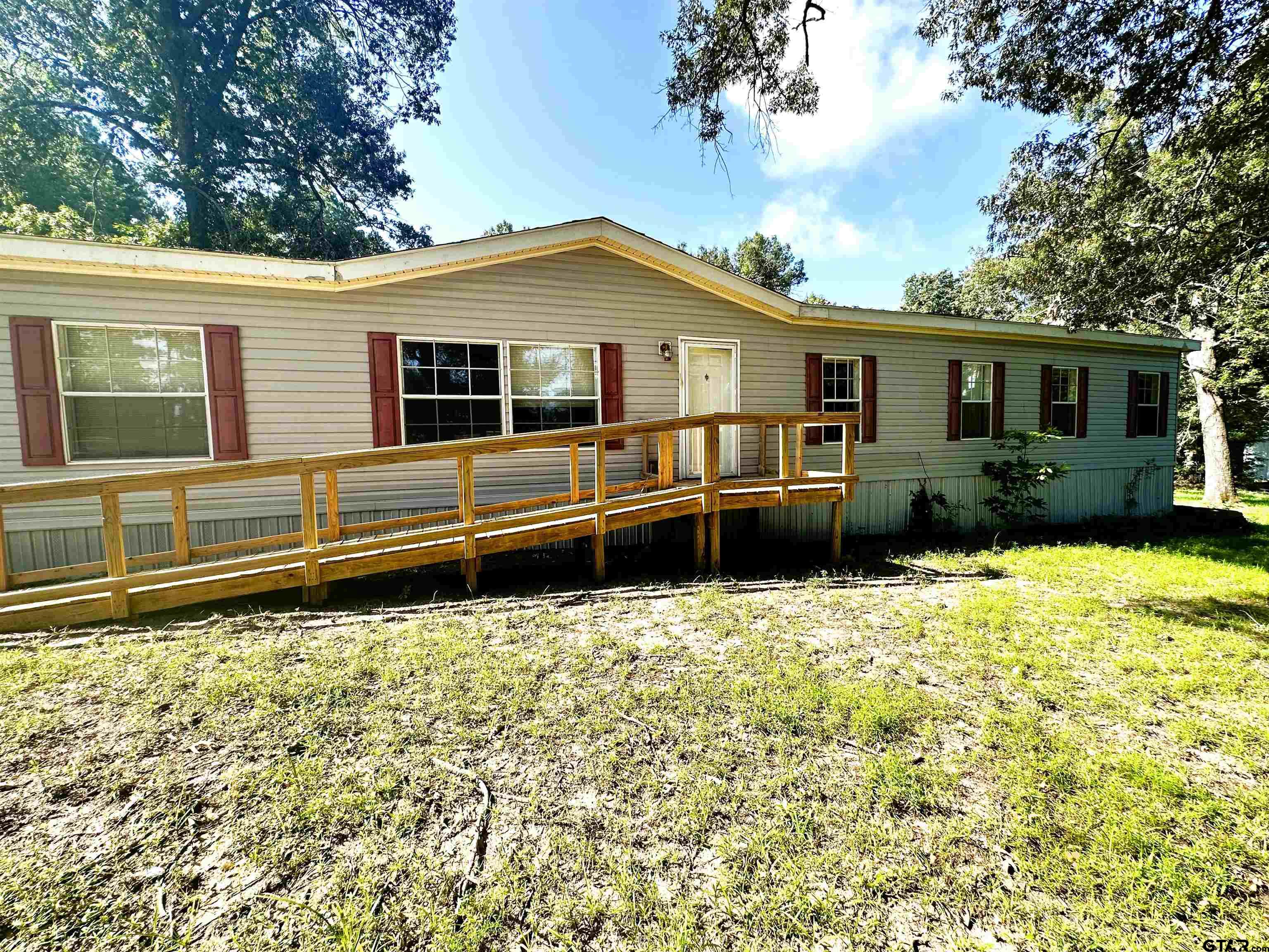 21232 Sand Jack Road Larue, TX 75770 - Photo 2 of 39 a house with trees in the background