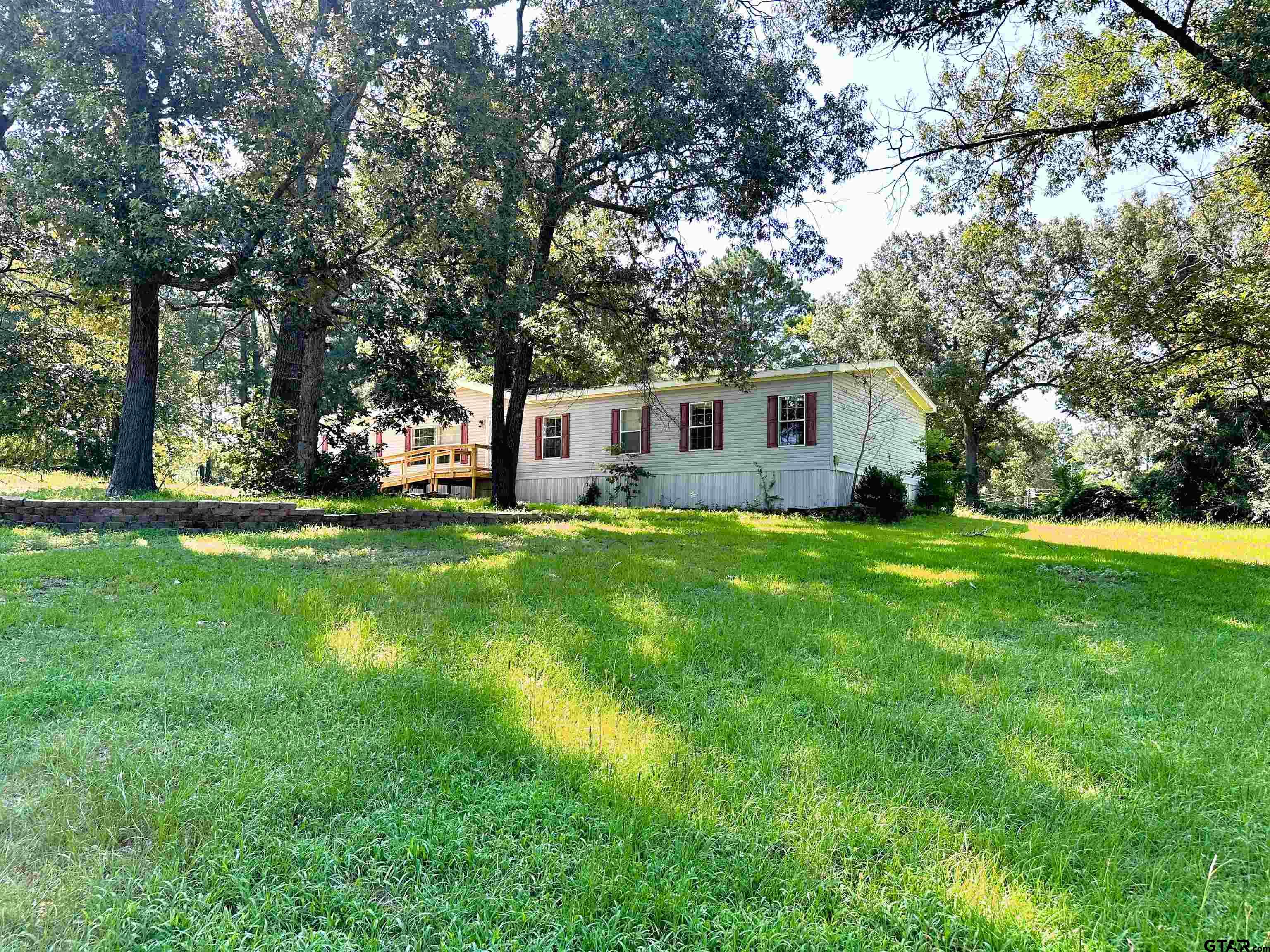 21232 Sand Jack Road Larue, TX 75770 - Photo 3 of 39 a view of house with a big yard and large trees