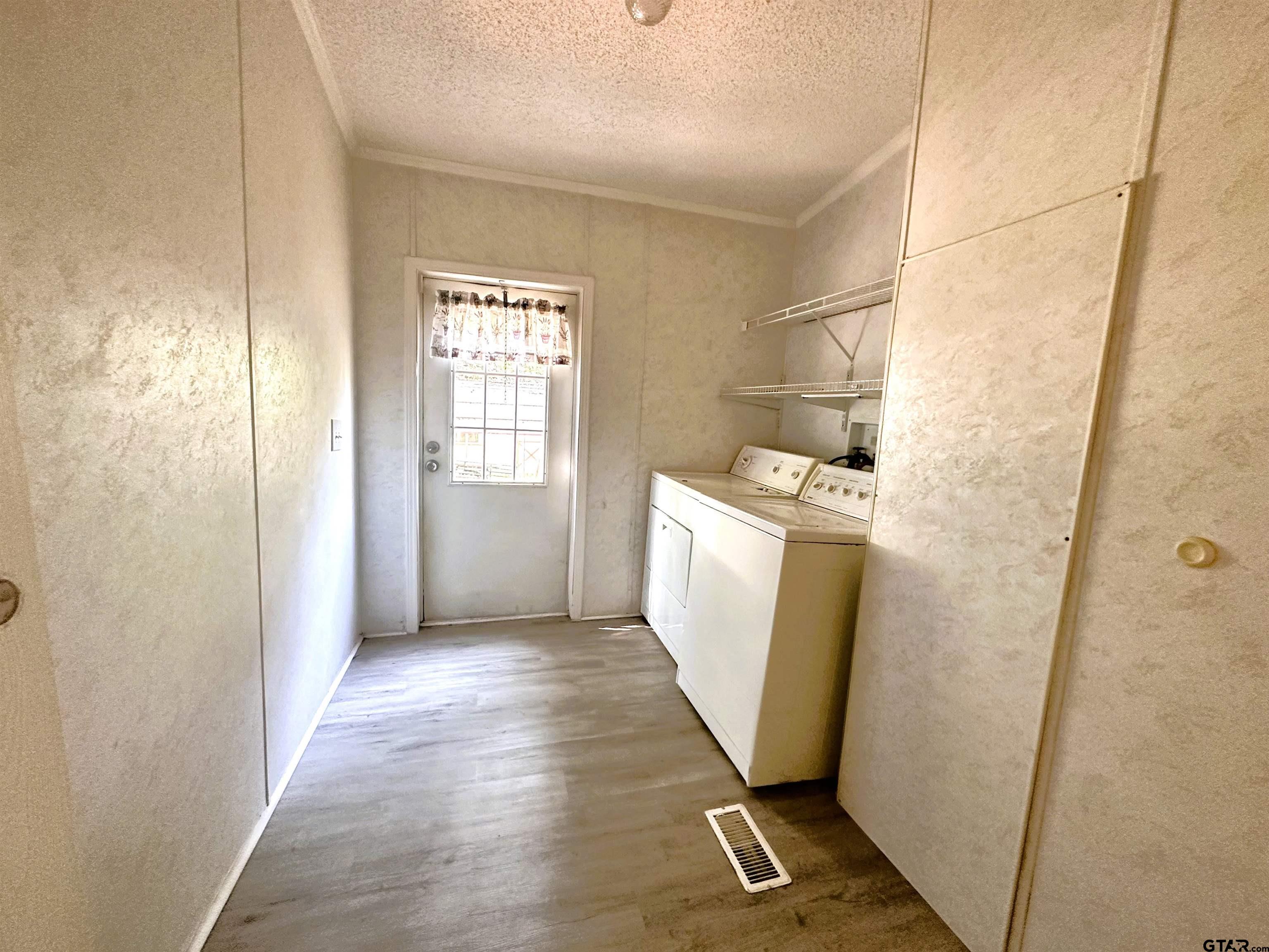21232 Sand Jack Road Larue, TX 75770 - Photo 32 of 39 a utility room with wooden floor washer and dryer