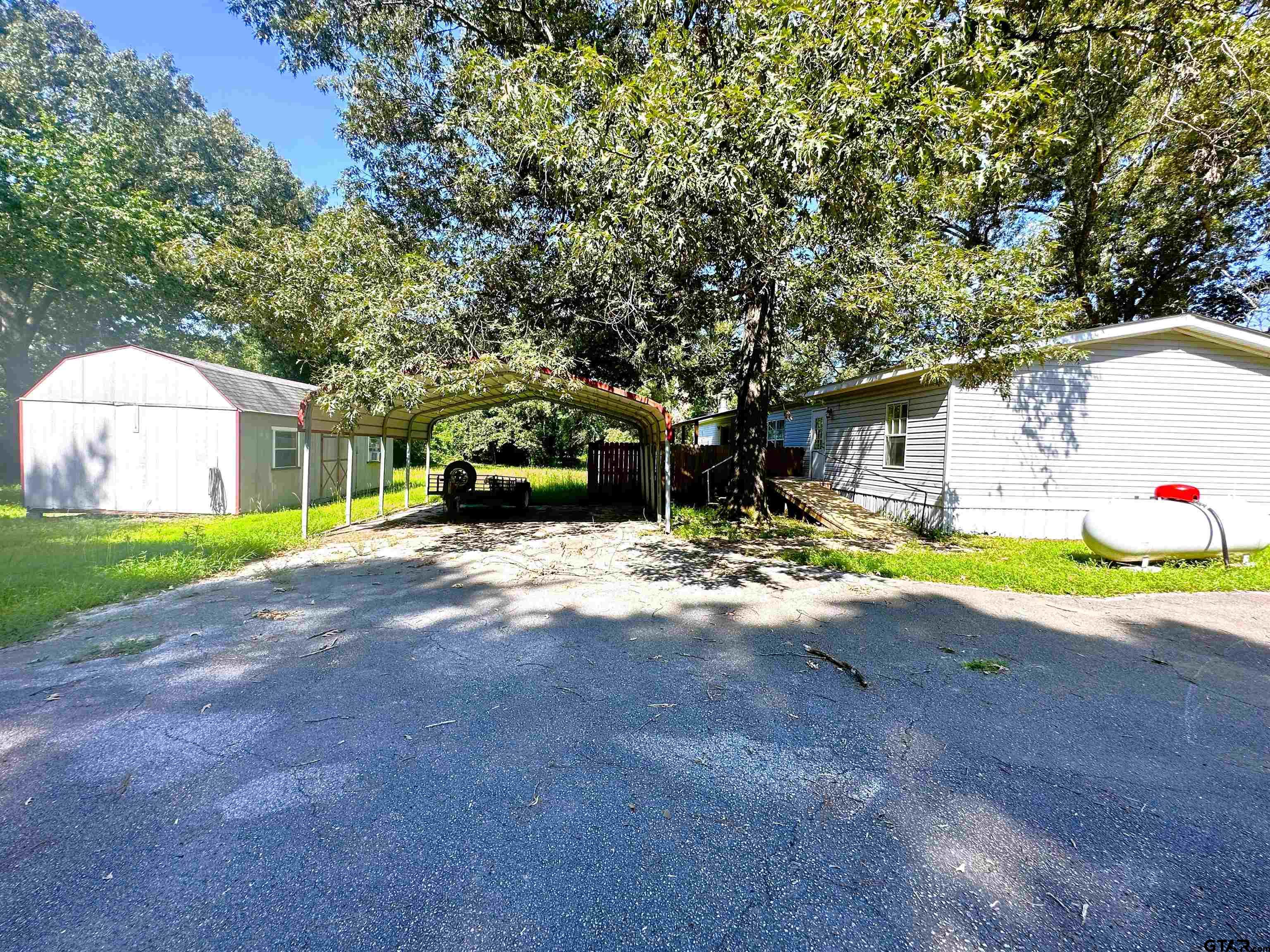21232 Sand Jack Road Larue, TX 75770 - Photo 34 of 39 a view of a house with a back yard