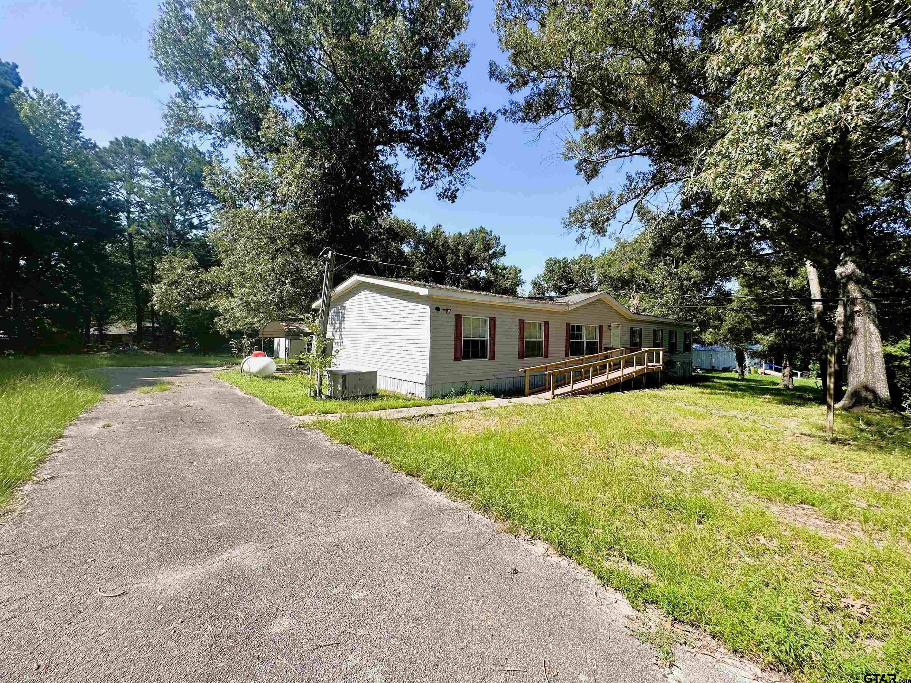 21232 Sand Jack Road Larue, TX 75770 - Photo 4 of 39 a front view of house with yard and trees