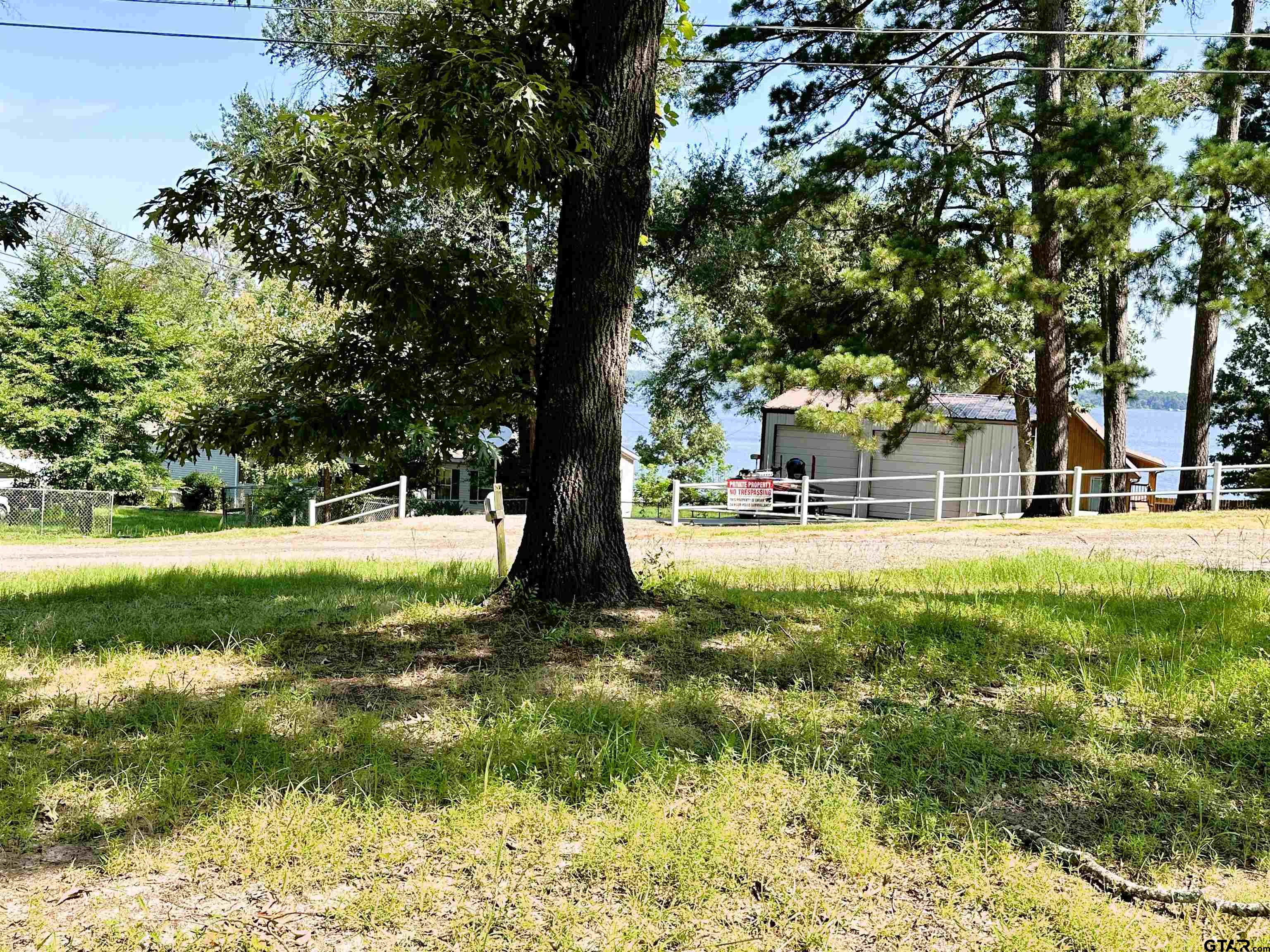21232 Sand Jack Road Larue, TX 75770 - Photo 5 of 39 a view of swimming pool with a garden and trees