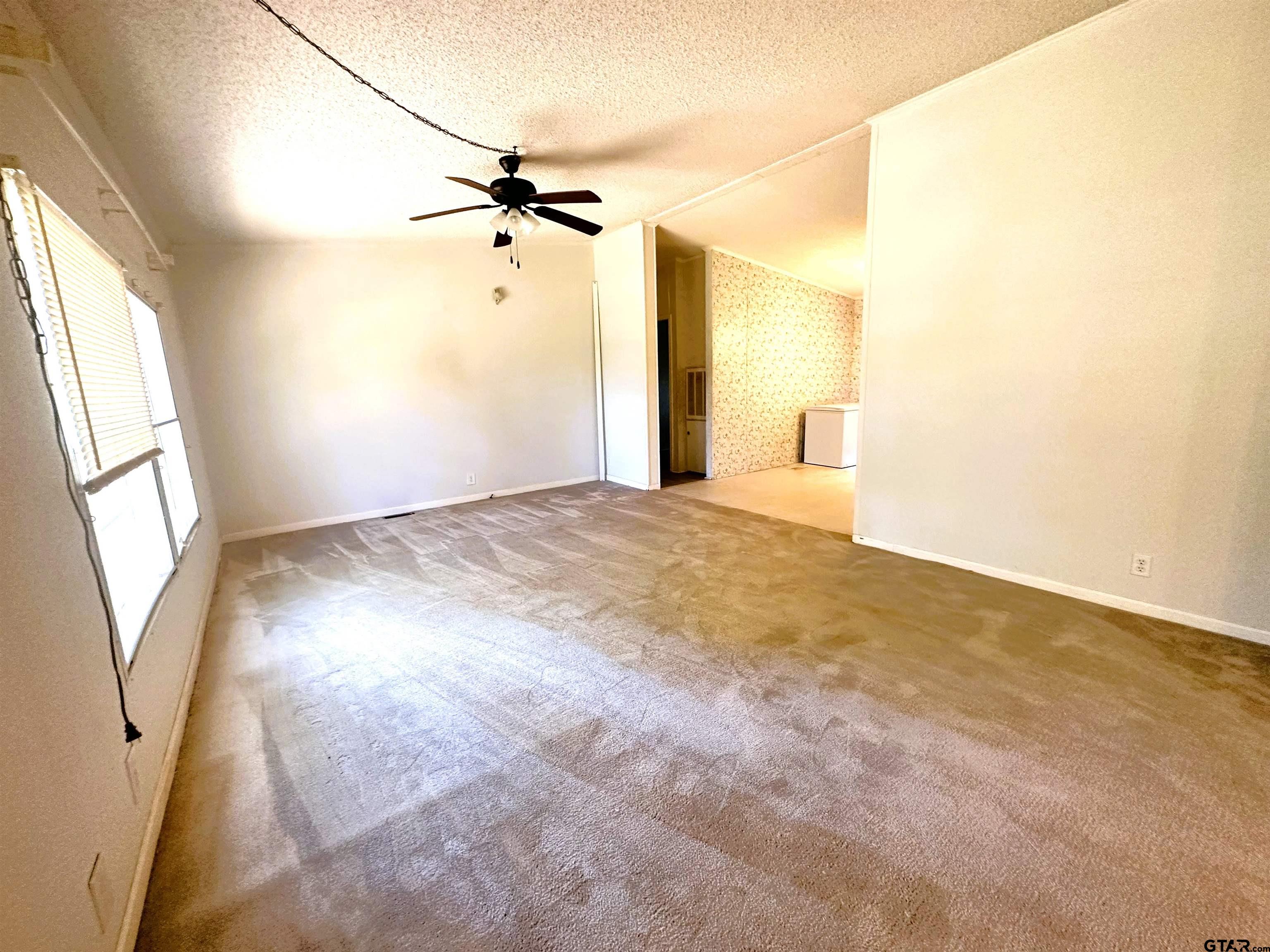 21232 Sand Jack Road Larue, TX 75770 - Photo 7 of 39 a view of a big room with windows and chandelier fan