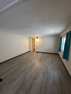 9001 South Cicero Avenue, Unit 134 Oak Lawn, IL 60453 - Photo 3 of 6 a view of an empty room with wooden floor and a window