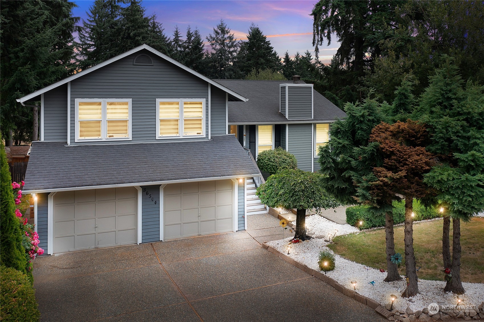 a front view of a house with yard and garage