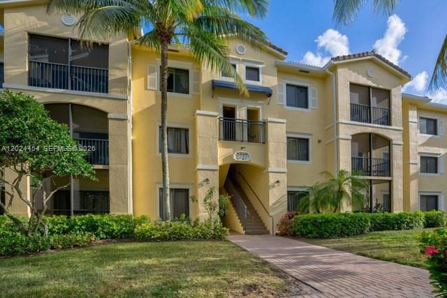 2727 Anzio Court, Unit 106 Palm Beach Gardens, FL 33410 - Photo 1 of 43 a front view of a house with a yard
