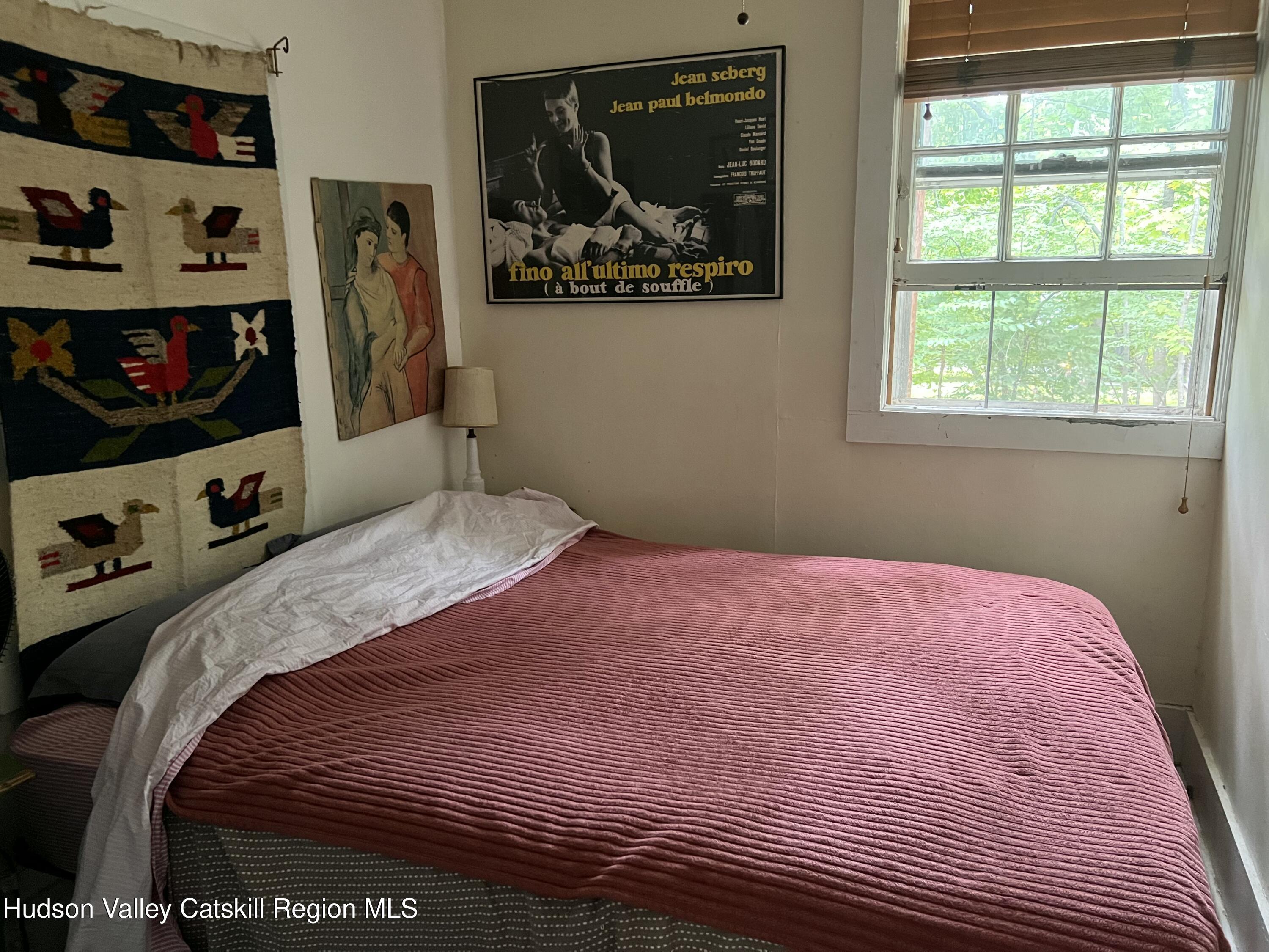 57 Ohayo Mountain Road Woodstock, NY 12498 - Photo 11 of 14 a bedroom with a bed and a window