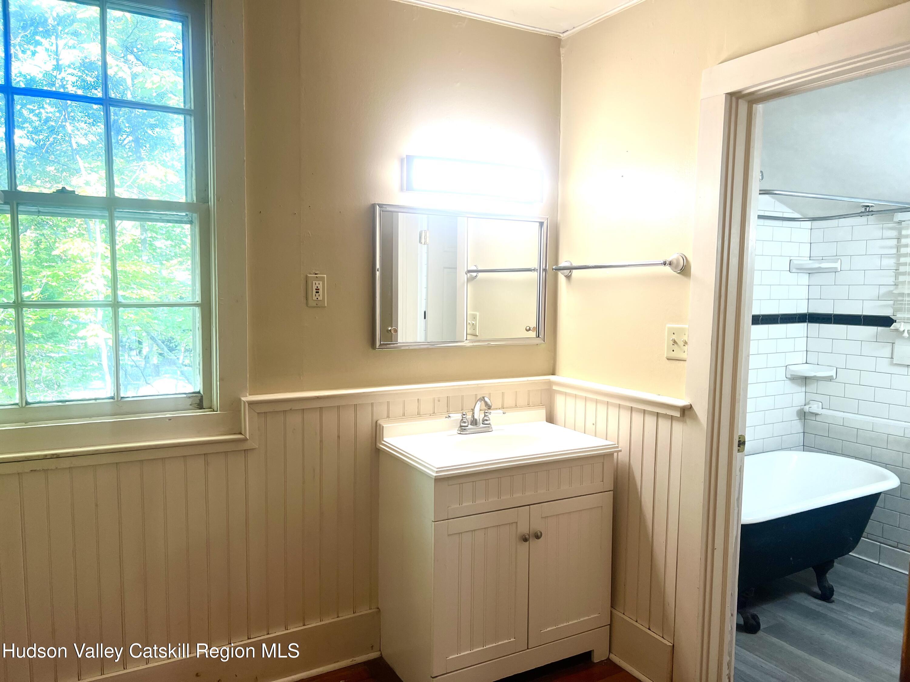 57 Ohayo Mountain Road Woodstock, NY 12498 - Photo 13 of 14 a bathroom with a sink a toilet and a window