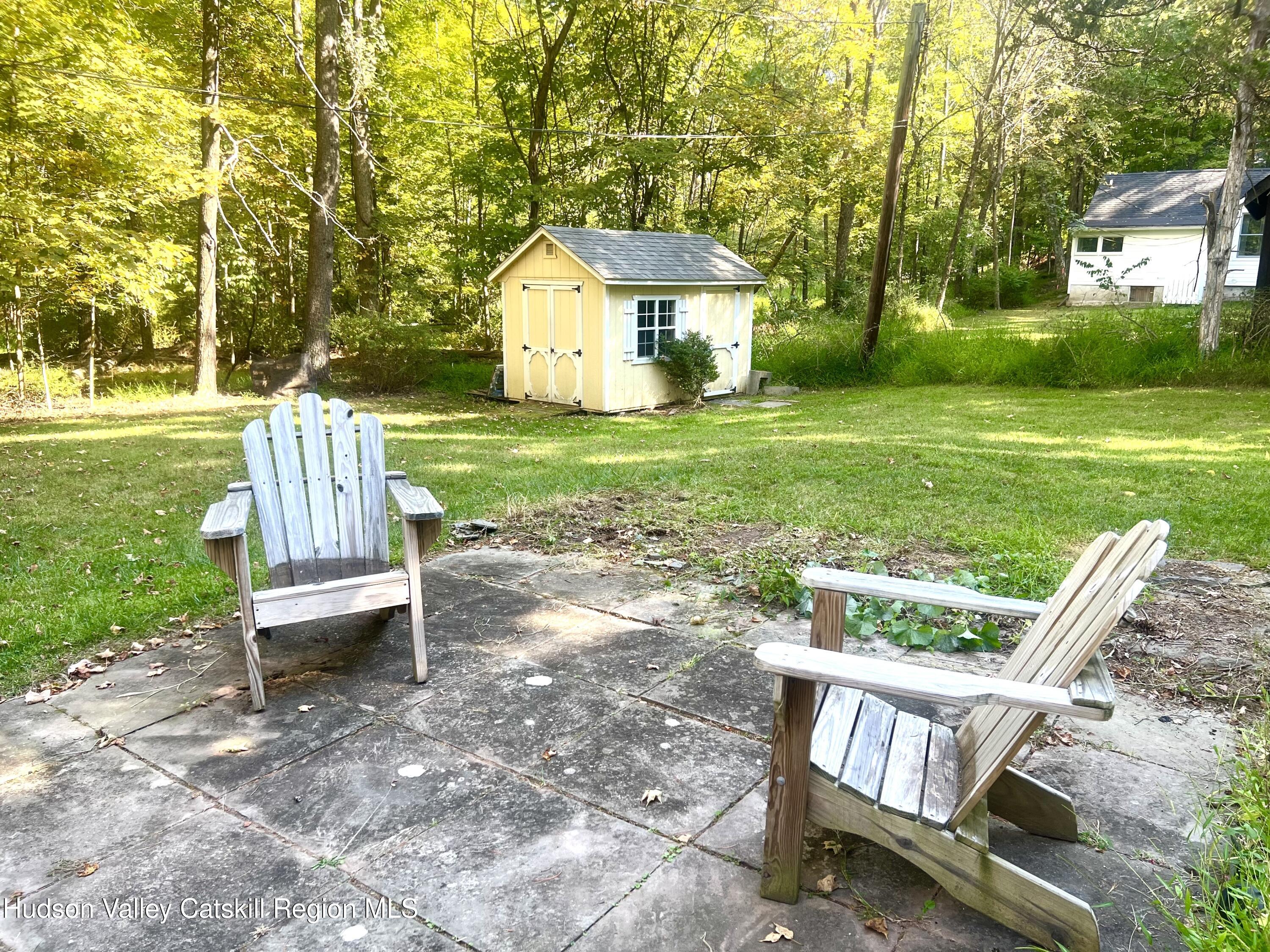 57 Ohayo Mountain Road Woodstock, NY 12498 - Photo 3 of 14 a front view of a house with garden and wooden fence