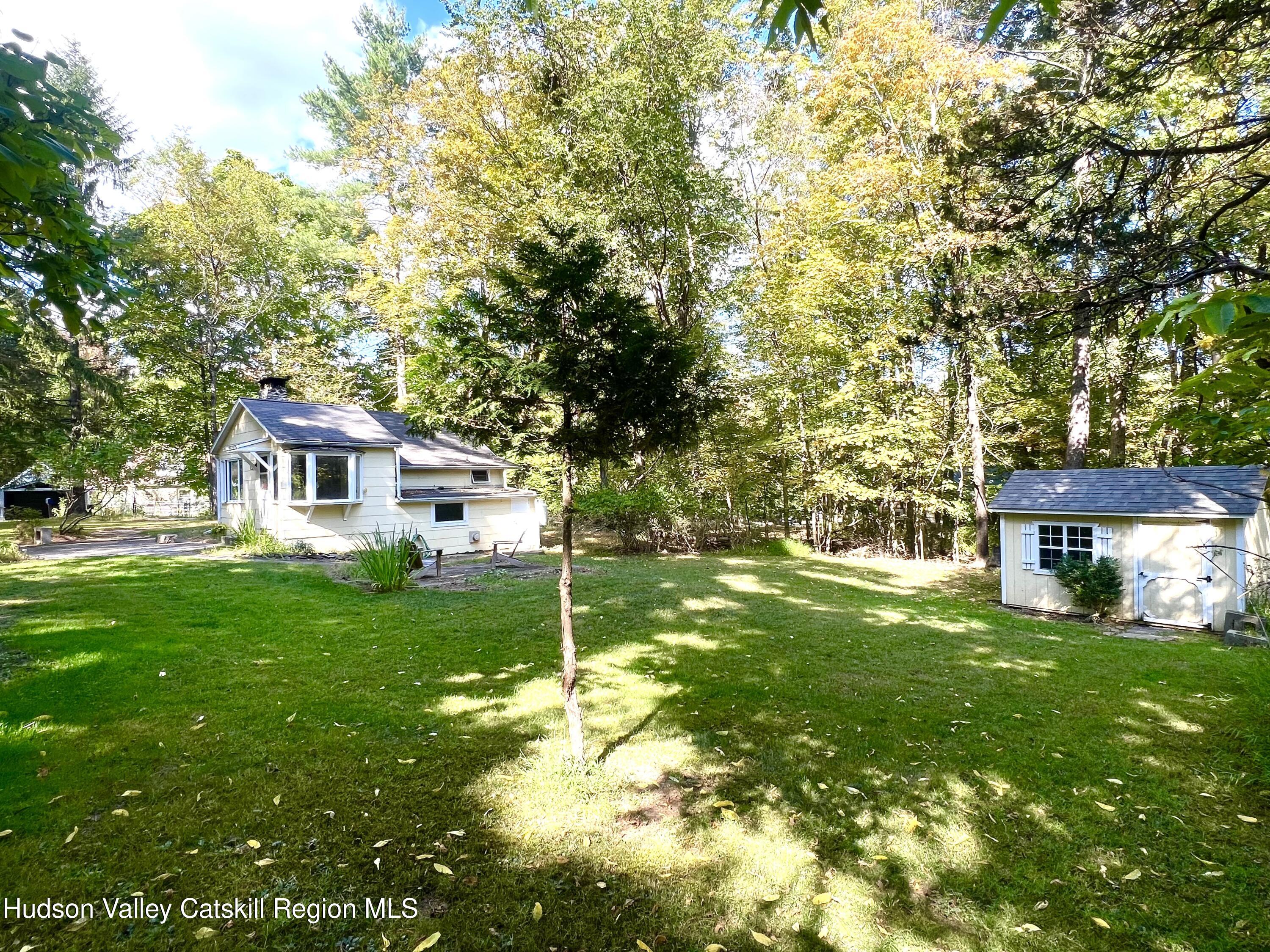 57 Ohayo Mountain Road Woodstock, NY 12498 - Photo 4 of 14 a front view of a house with garden