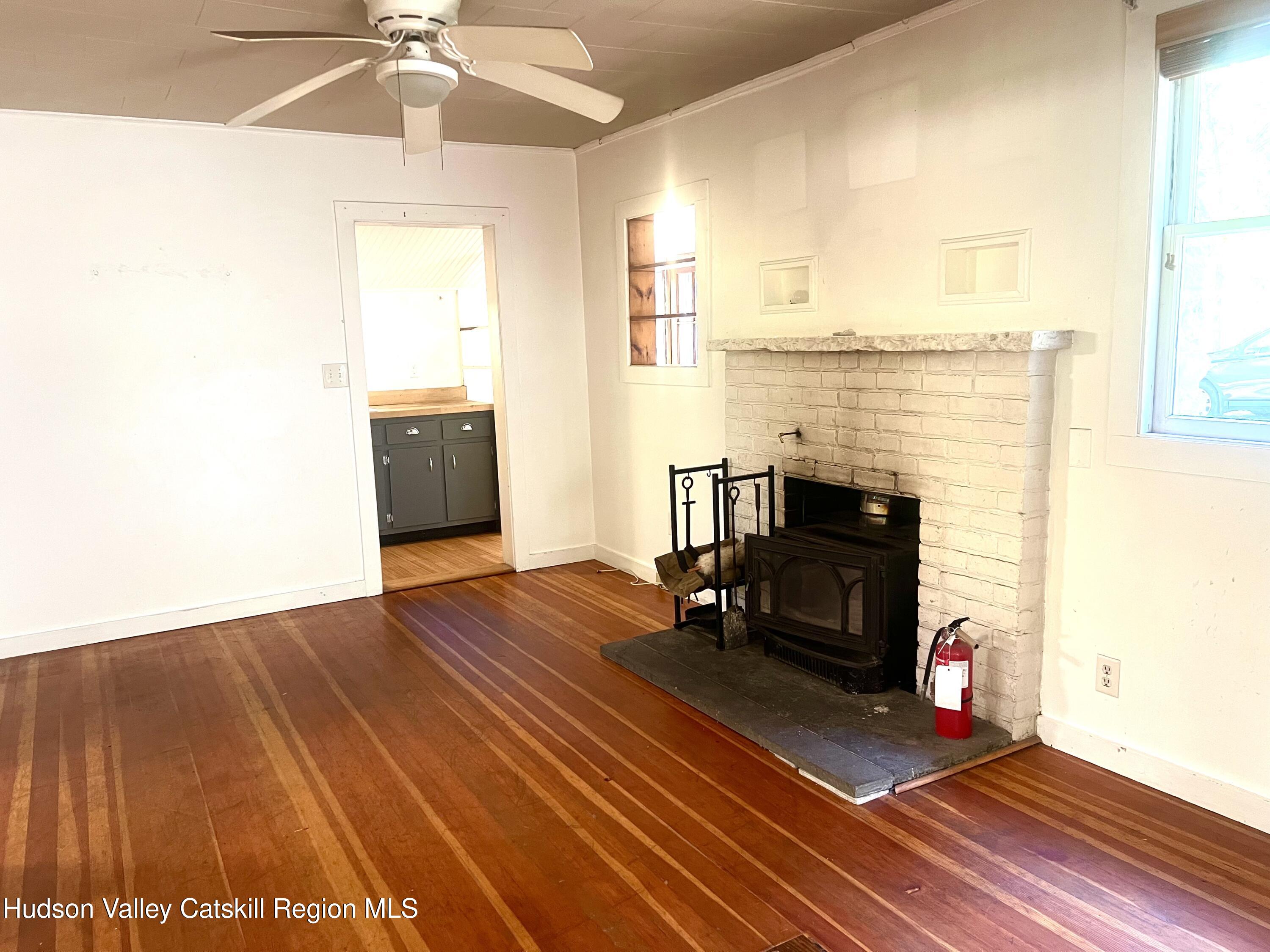 57 Ohayo Mountain Road Woodstock, NY 12498 - Photo 8 of 14 a living room with furniture and a fireplace