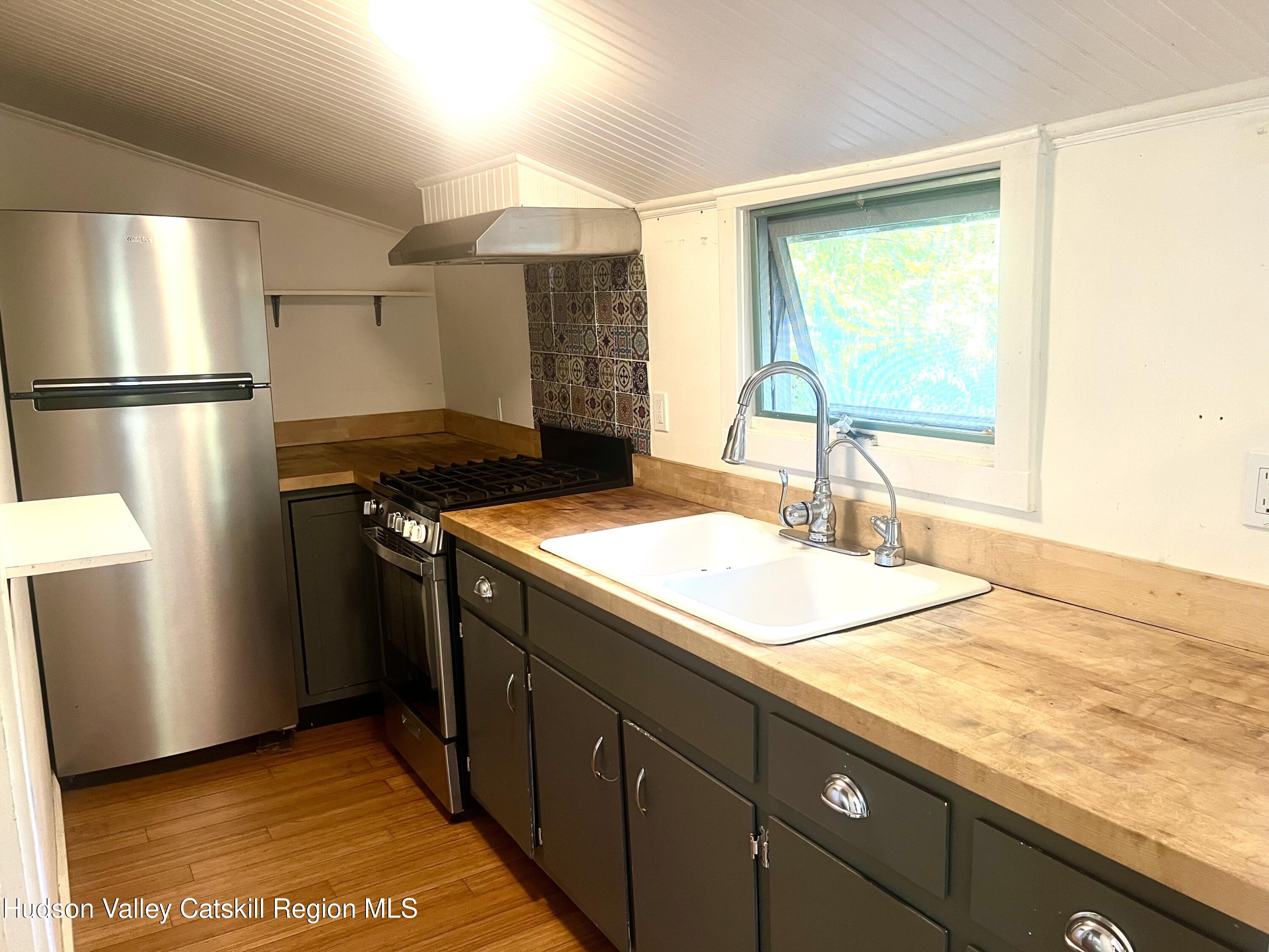 57 Ohayo Mountain Road Woodstock, NY 12498 - Photo 10 of 14 a kitchen with stainless steel appliances granite countertop a sink stove and refrigerator