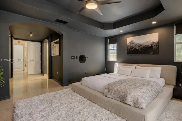 a bedroom with a bed and a flat screen tv