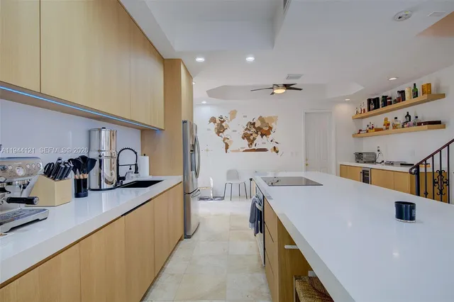 a kitchen with a sink a stove and cabinets