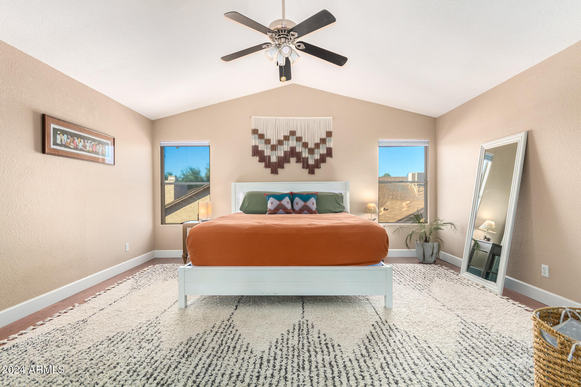 1836 North Stapley Drive, Unit 102 Mesa, AZ 85203 - Photo 19 of 34 a bedroom with a large bed and a chandelier