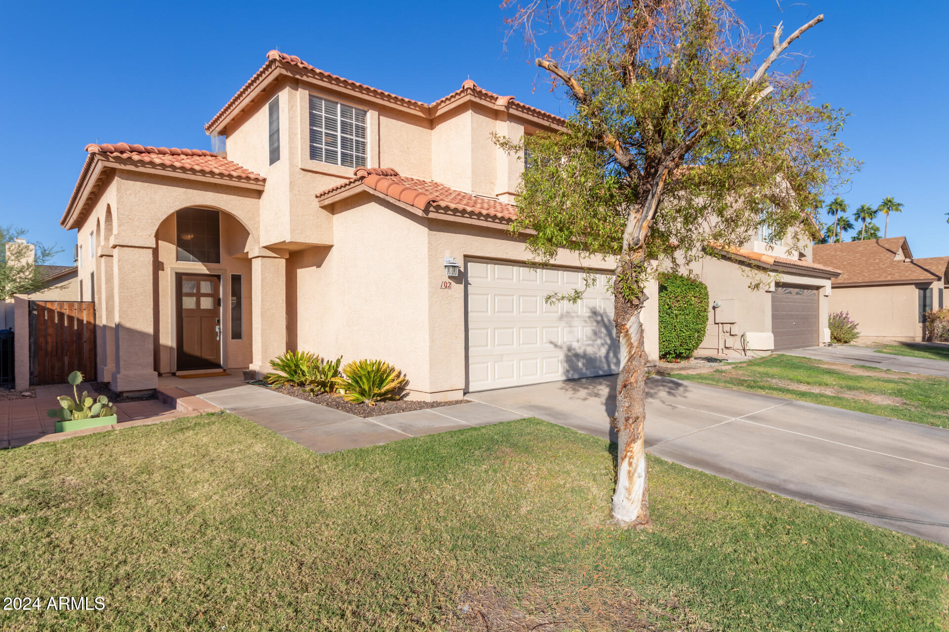 1836 North Stapley Drive, Unit 102 Mesa, AZ 85203 - Photo 2 of 34 a front view of a house with garden