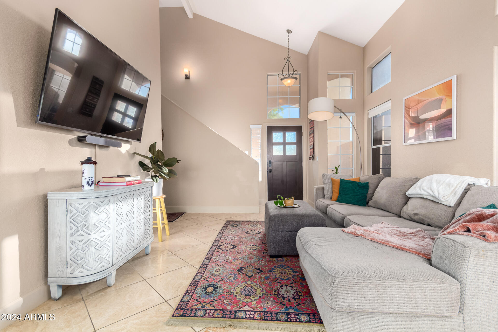 1836 North Stapley Drive, Unit 102 Mesa, AZ 85203 - Photo 7 of 34 a living room with furniture and a flat screen tv