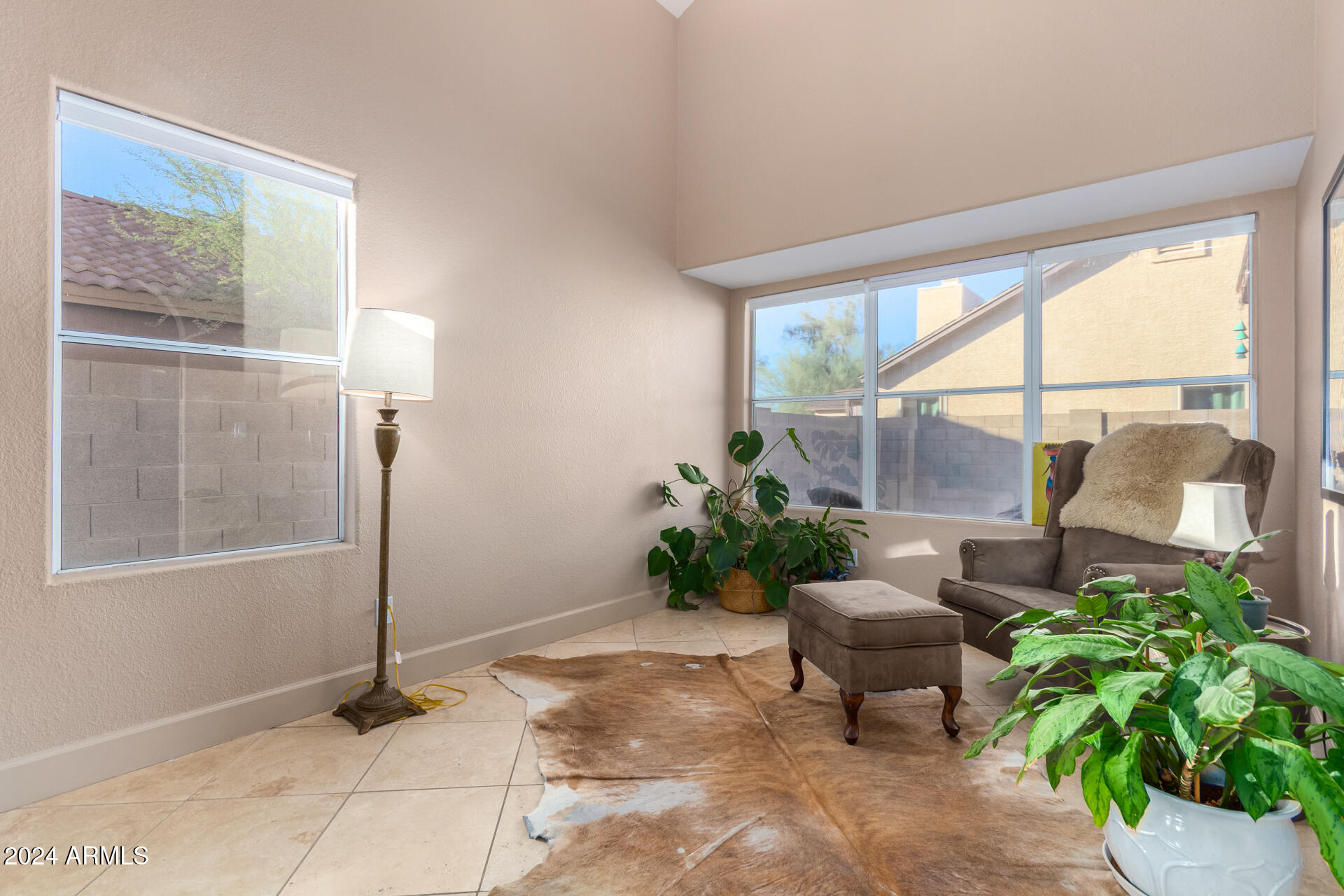 1836 North Stapley Drive, Unit 102 Mesa, AZ 85203 - Photo 9 of 34 a living room with furniture and a potted plant
