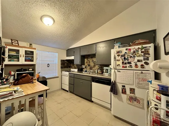 a kitchen with cabinets and window