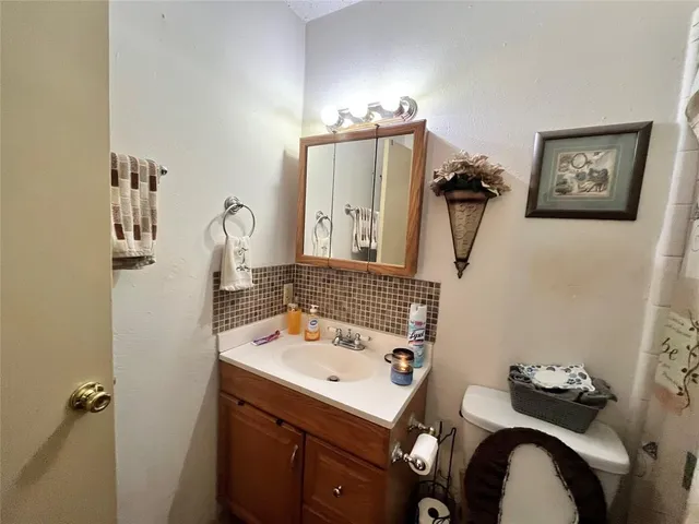 a bathroom with a sink vanity and a mirror