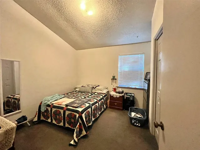 a bedroom with a bed and a desk