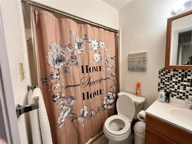 a white toilet sitting next to a bathroom sink