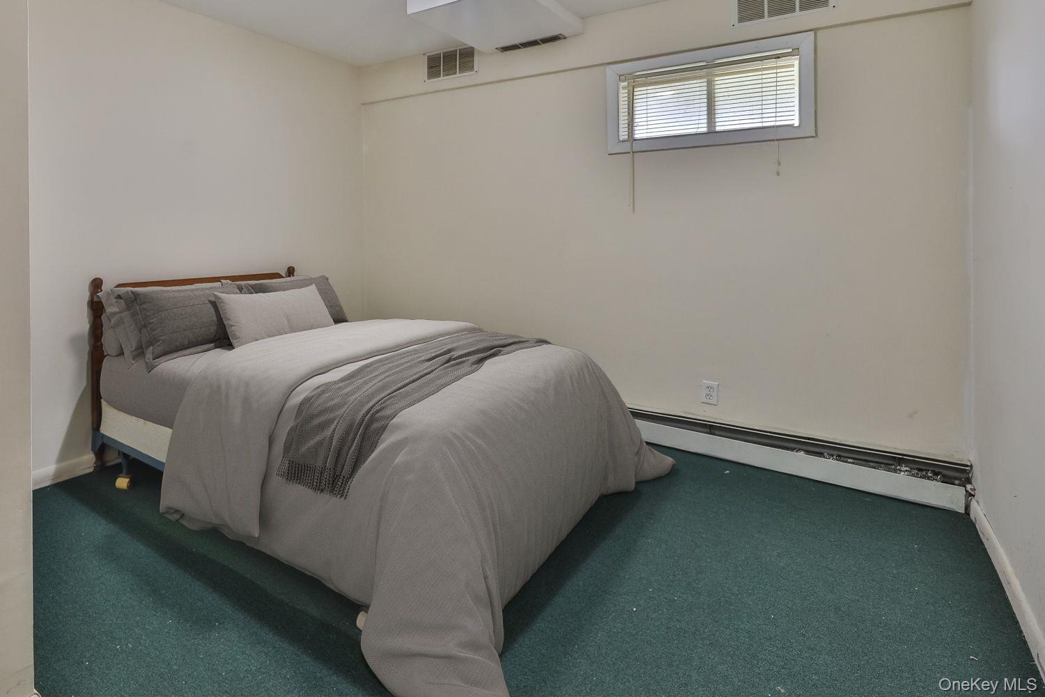 559 Case Road Ashland, NY 12496 - Photo 24 of 33 a bed sitting in a bedroom next to a window