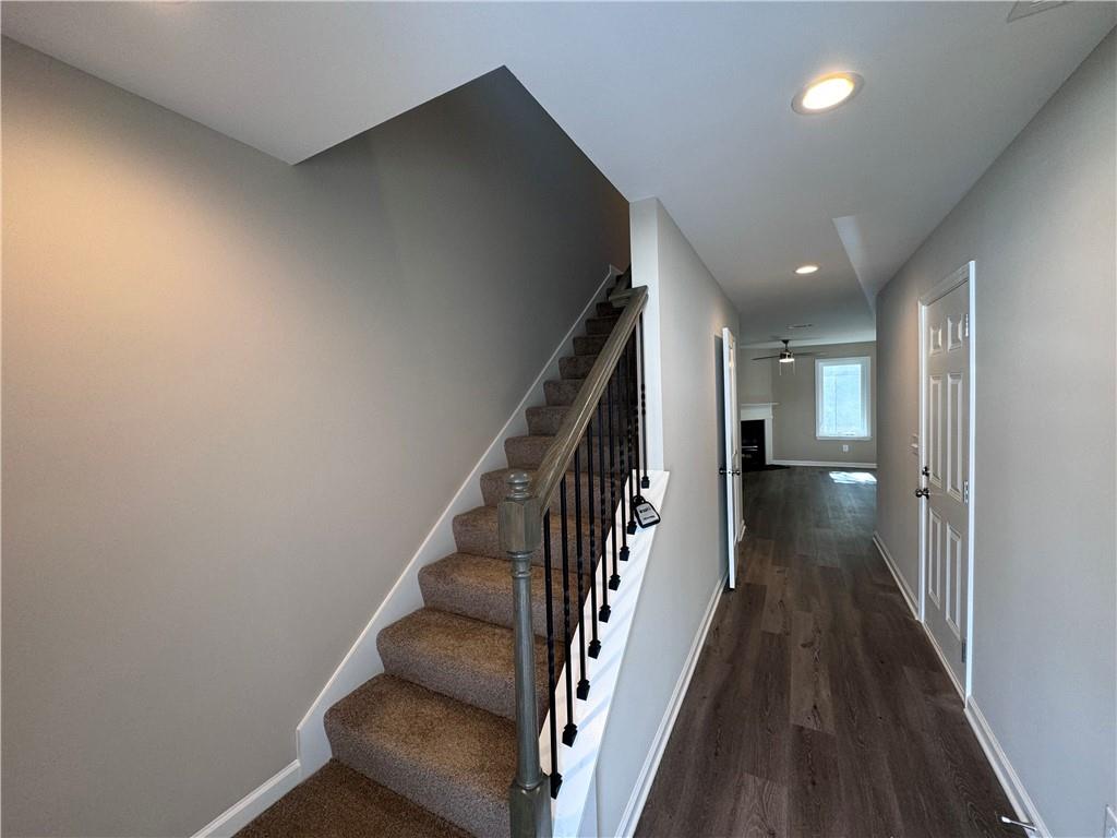 a view of entryway and hall with wooden floor