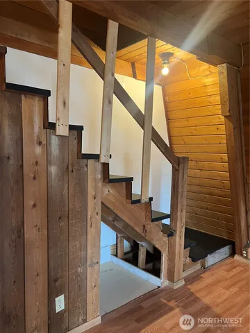 a view of entryway and hall with wooden floor