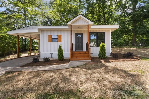 a front view of a house with garden