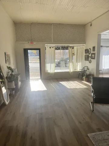 a spacious bedroom with a balcony a bed and large windows