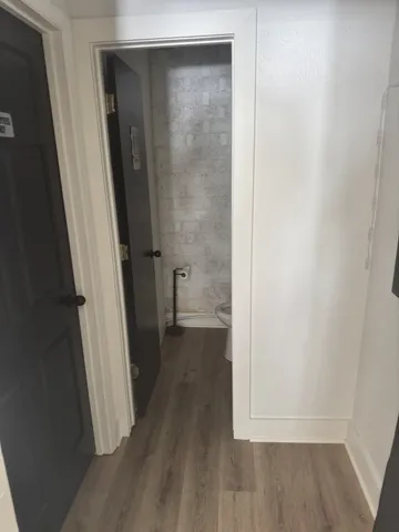 an empty room with wooden floor and a window