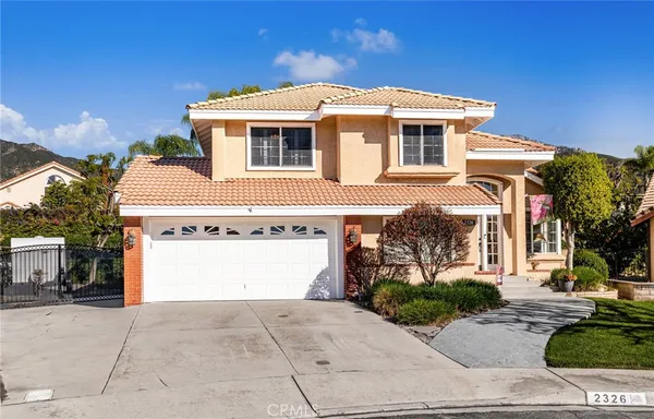 a front view of a house with a garage
