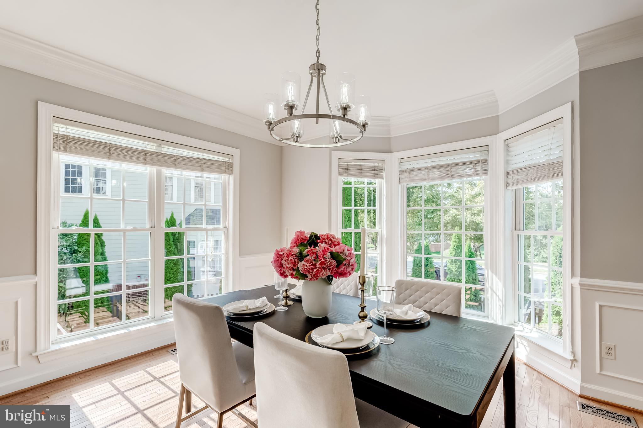19111 Chartier Drive Leesburg, VA 20176 - Photo 12 of 68 a dining room with furniture large windows and wooden floor