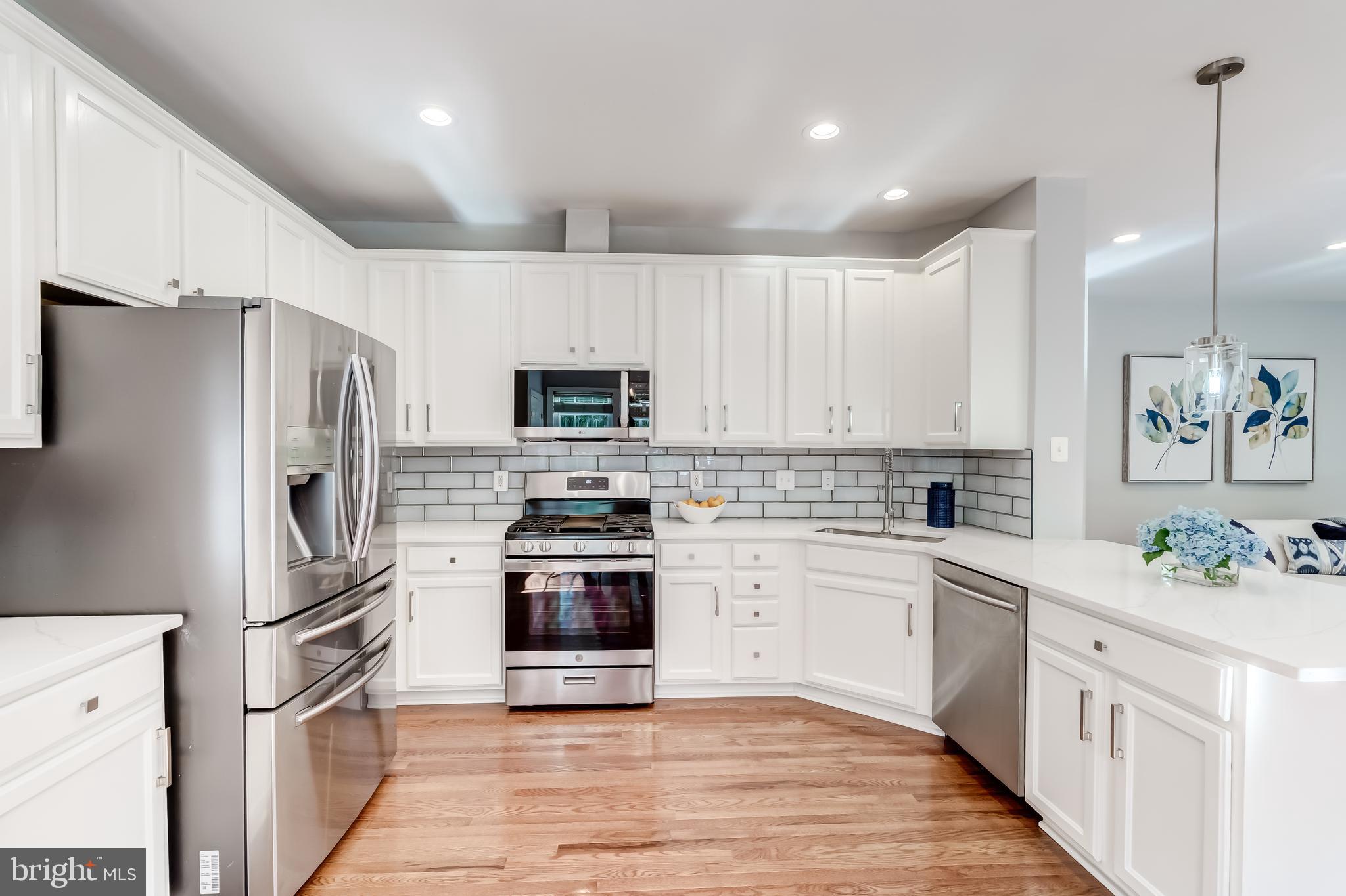 19111 Chartier Drive Leesburg, VA 20176 - Photo 14 of 68 a kitchen with cabinets stainless steel appliances and a counter space