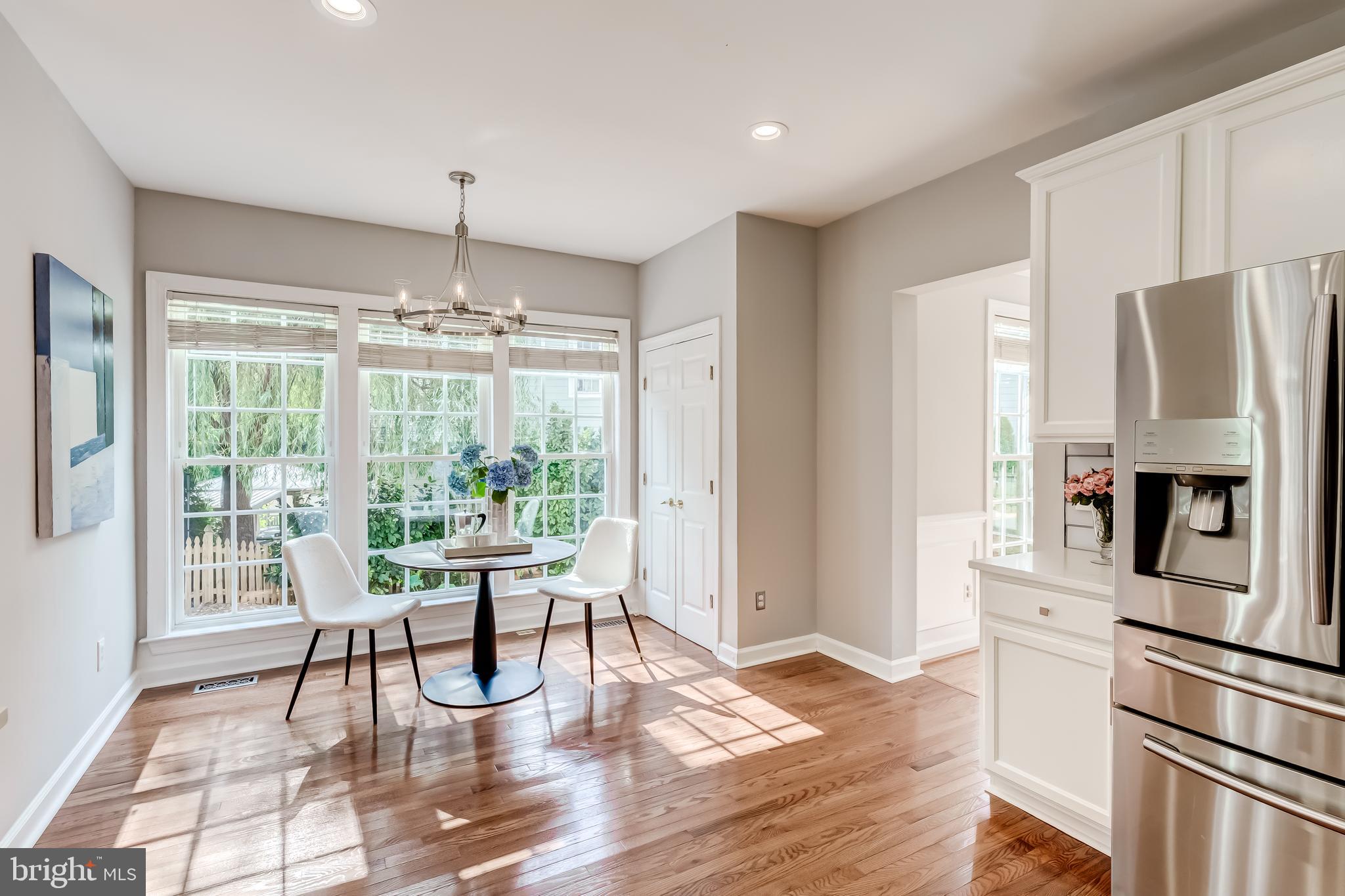 19111 Chartier Drive Leesburg, VA 20176 - Photo 16 of 68 a dining room with wooden floor a chandelier a glass table and chairs