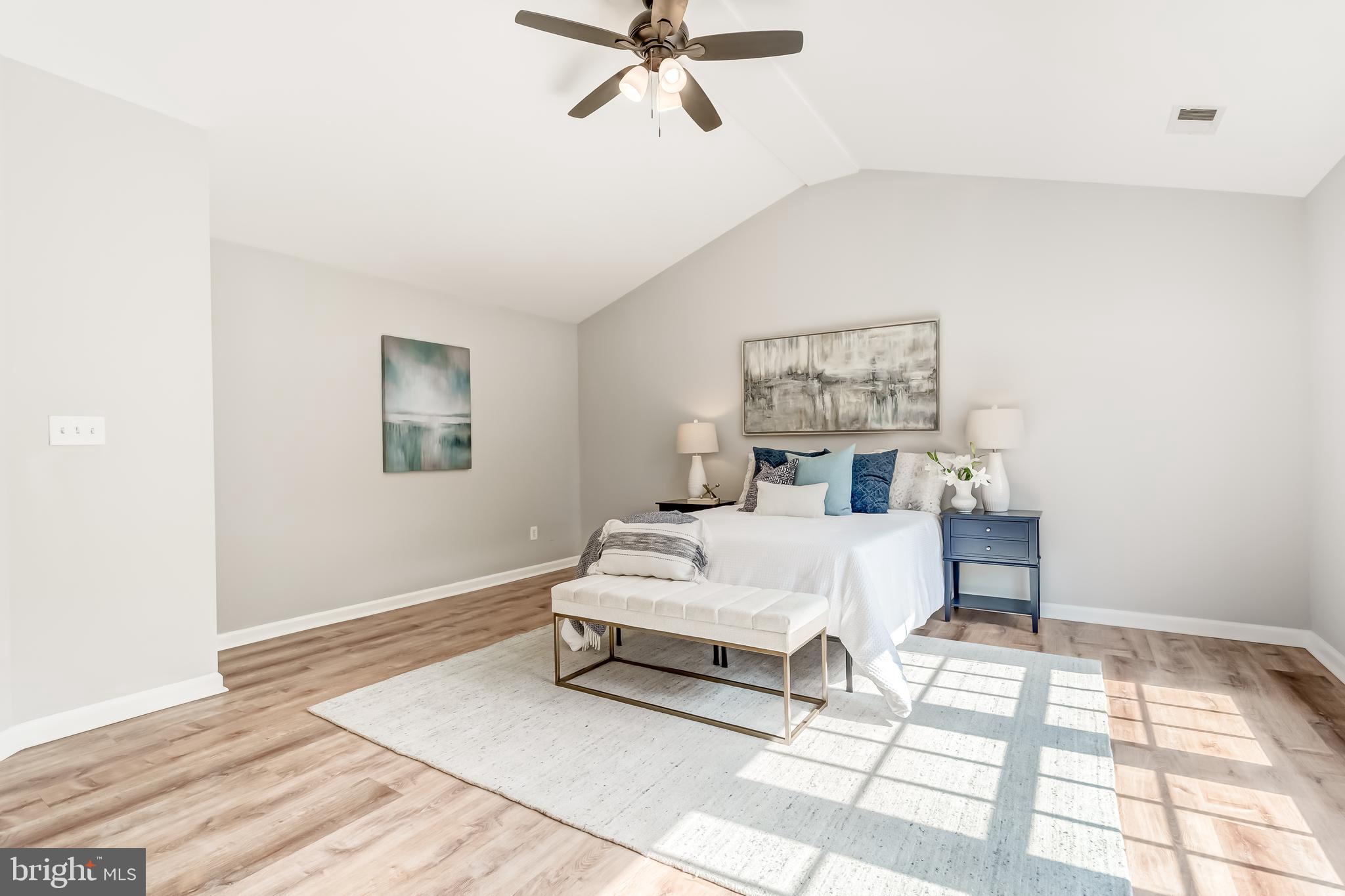19111 Chartier Drive Leesburg, VA 20176 - Photo 24 of 68 a spacious bedroom with a bed painting on wall and a window