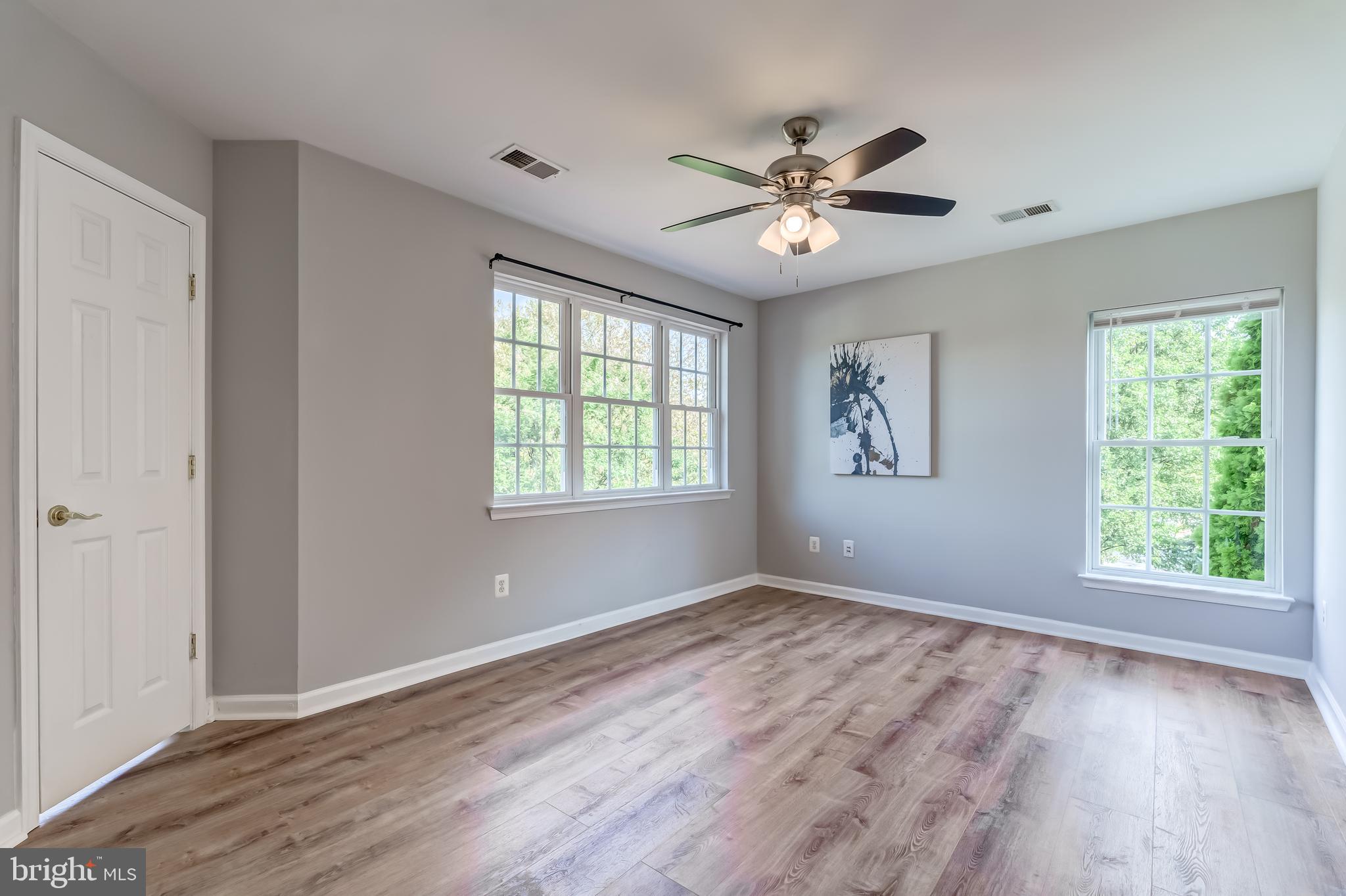 19111 Chartier Drive Leesburg, VA 20176 - Photo 28 of 68 a view of an empty room with wooden floor and a window