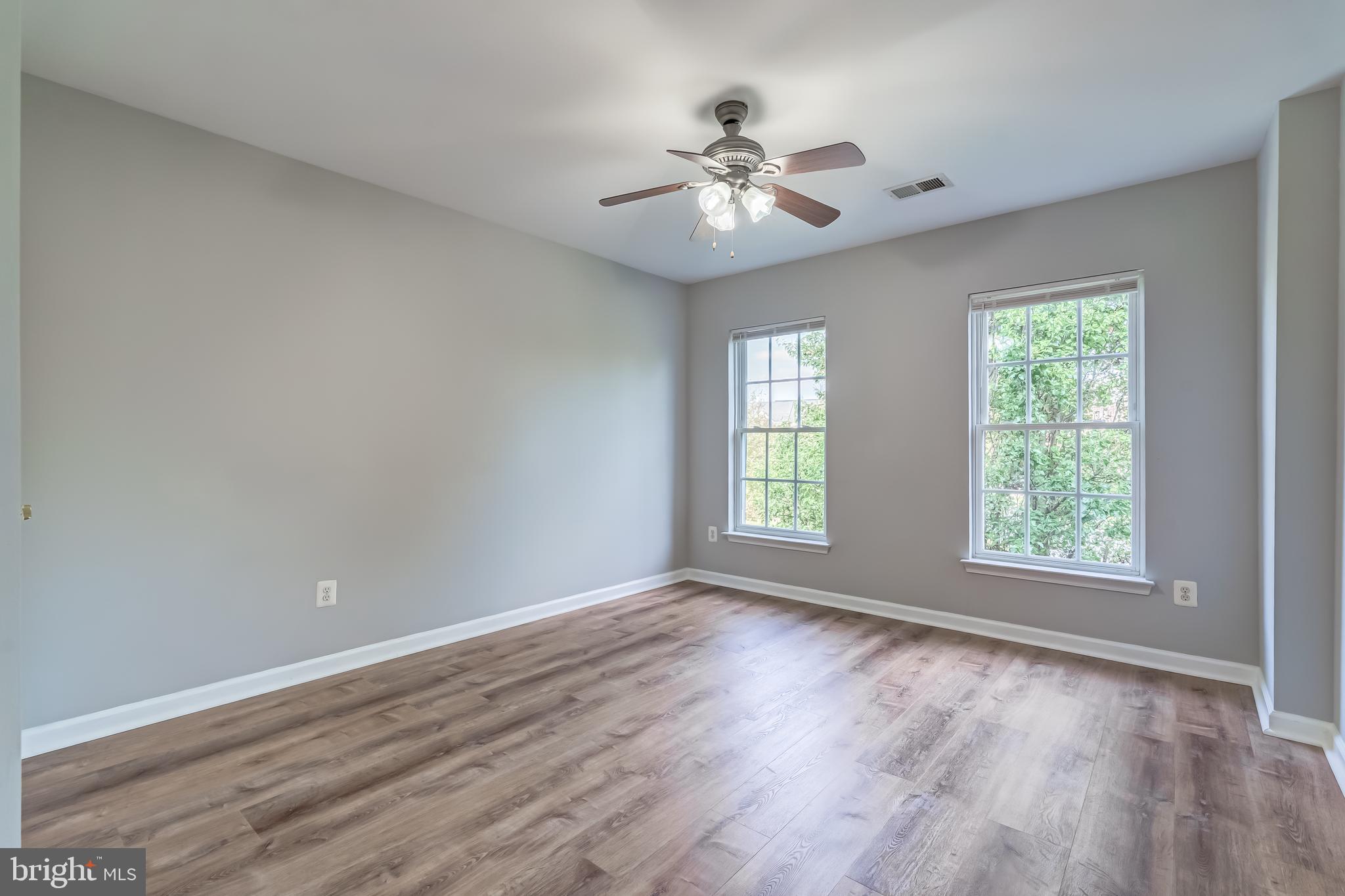 19111 Chartier Drive Leesburg, VA 20176 - Photo 31 of 68 a view of an empty room with wooden floor and a window