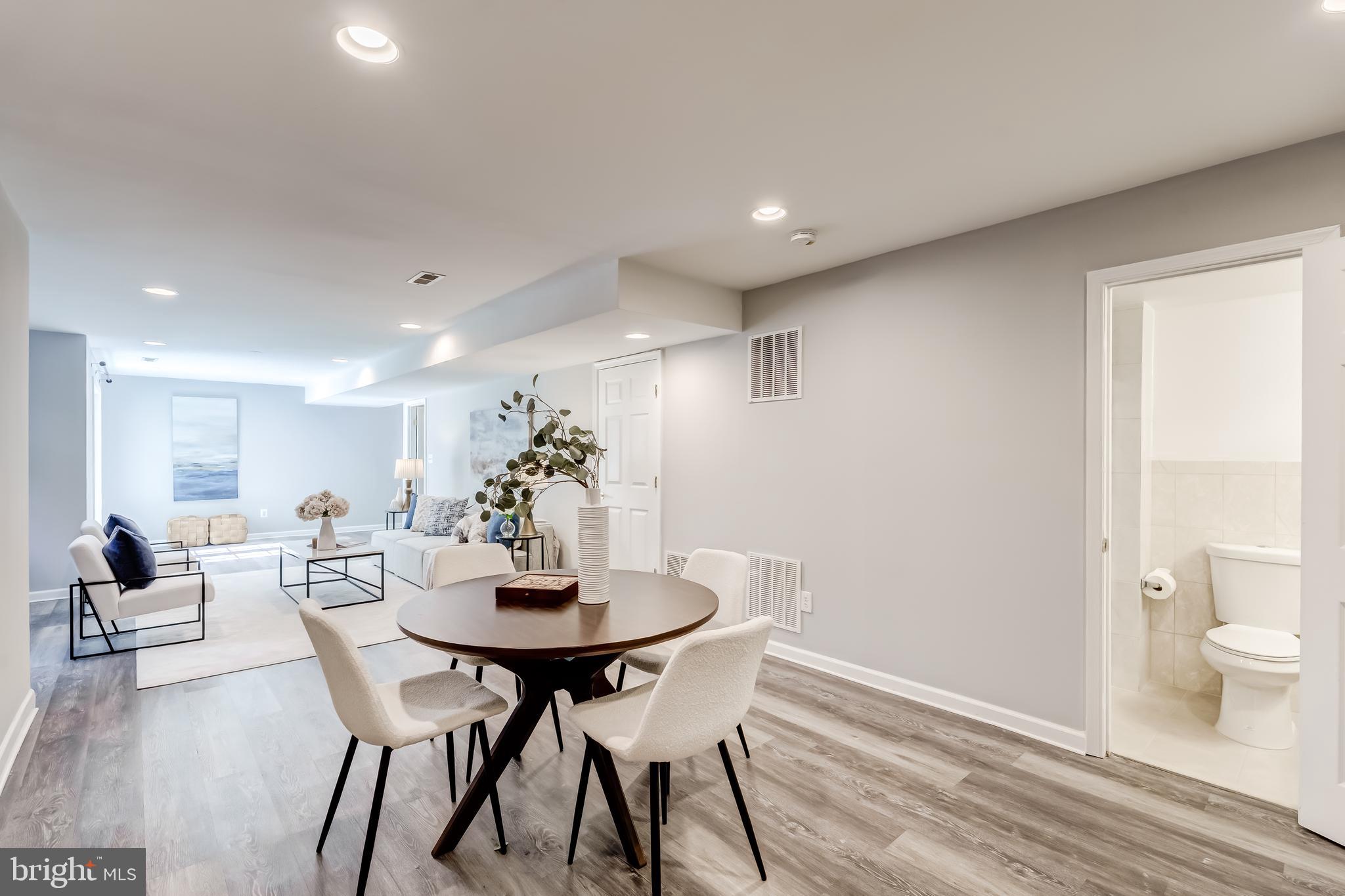 19111 Chartier Drive Leesburg, VA 20176 - Photo 42 of 68 a view of a dining room with furniture and wooden floor