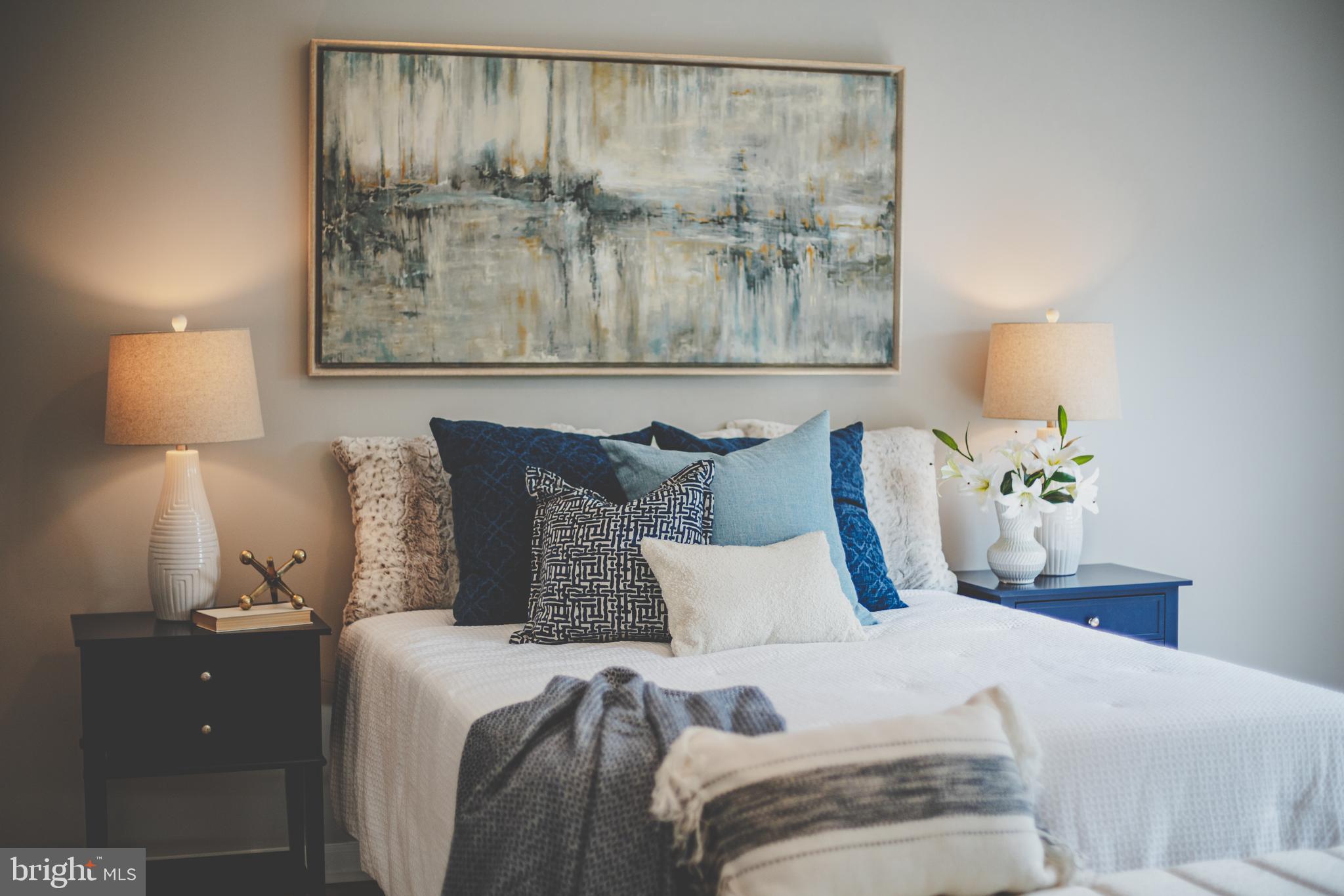 19111 Chartier Drive Leesburg, VA 20176 - Photo 61 of 68 a bedroom with a bed and painting on the wall