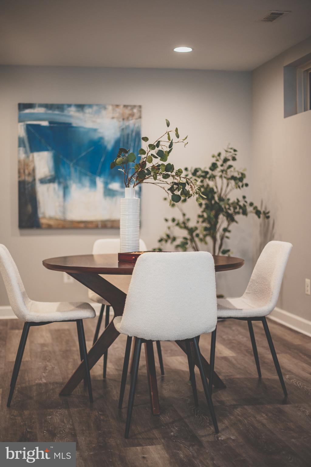 19111 Chartier Drive Leesburg, VA 20176 - Photo 63 of 68 a view of a dining room with furniture and wooden floor