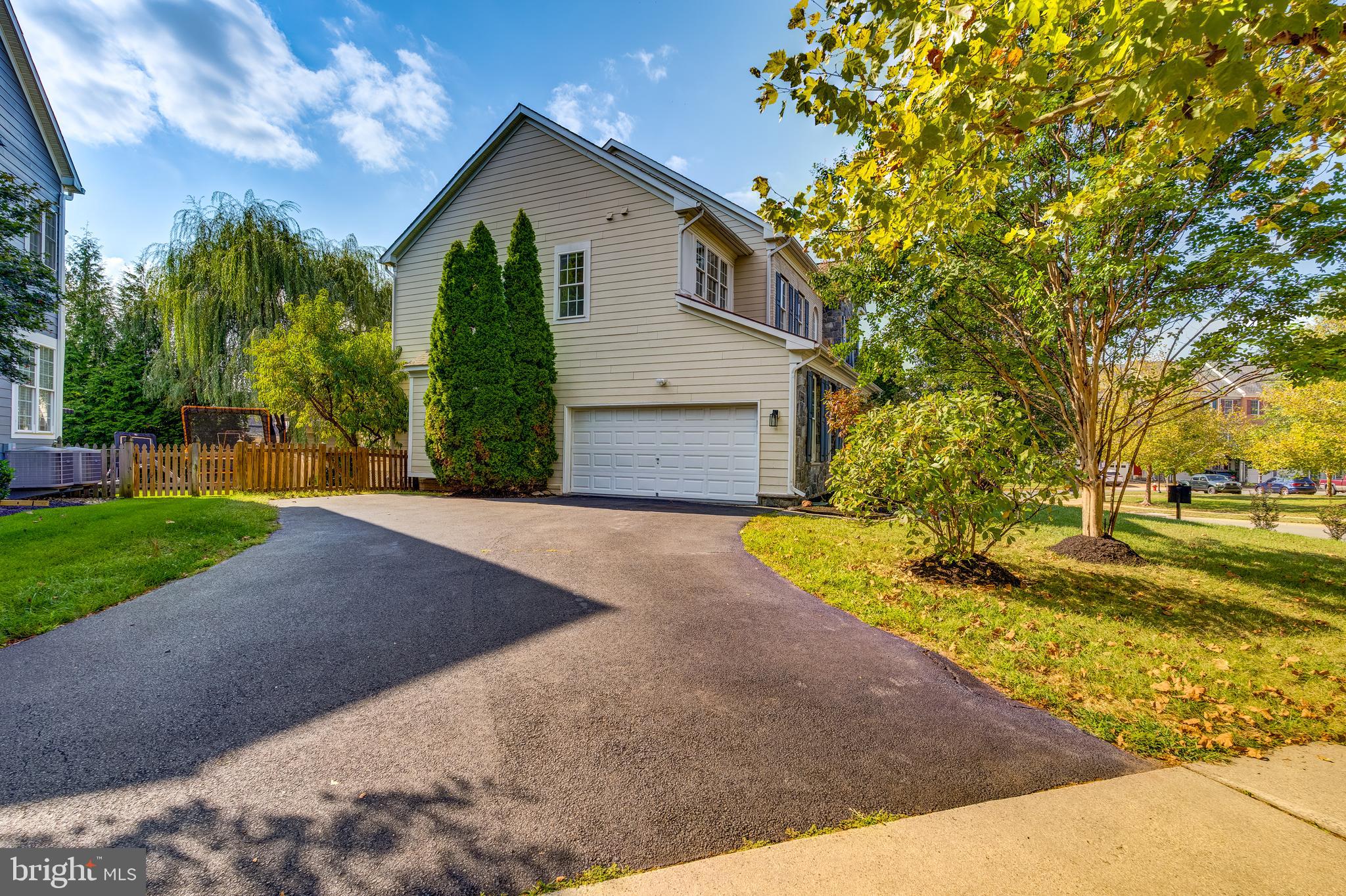 19111 Chartier Drive Leesburg, VA 20176 - Photo 66 of 68 a front view of a house with a yard and garage