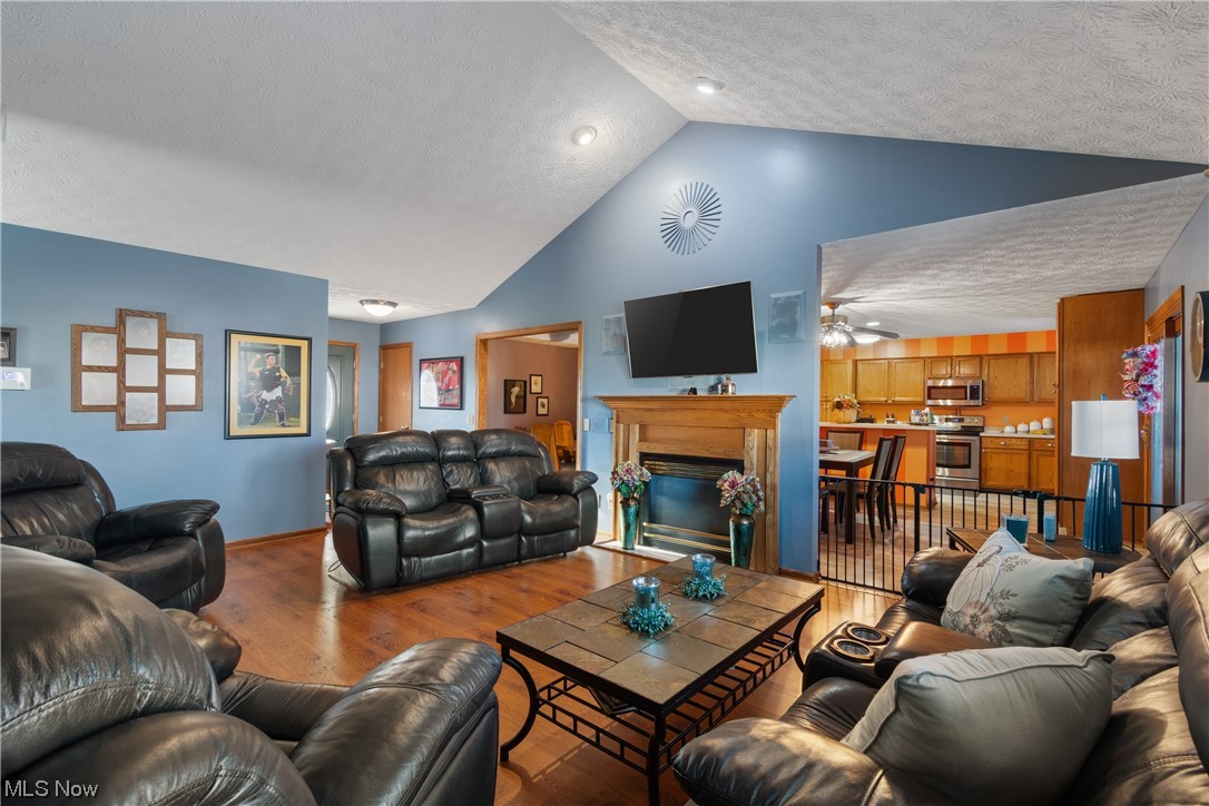 8366 Turquoise Avenue Northeast Canton, OH 44721 - Photo 3 of 26 Great room w/ high vaulted ceiling, gas fireplace and built in surround sound.